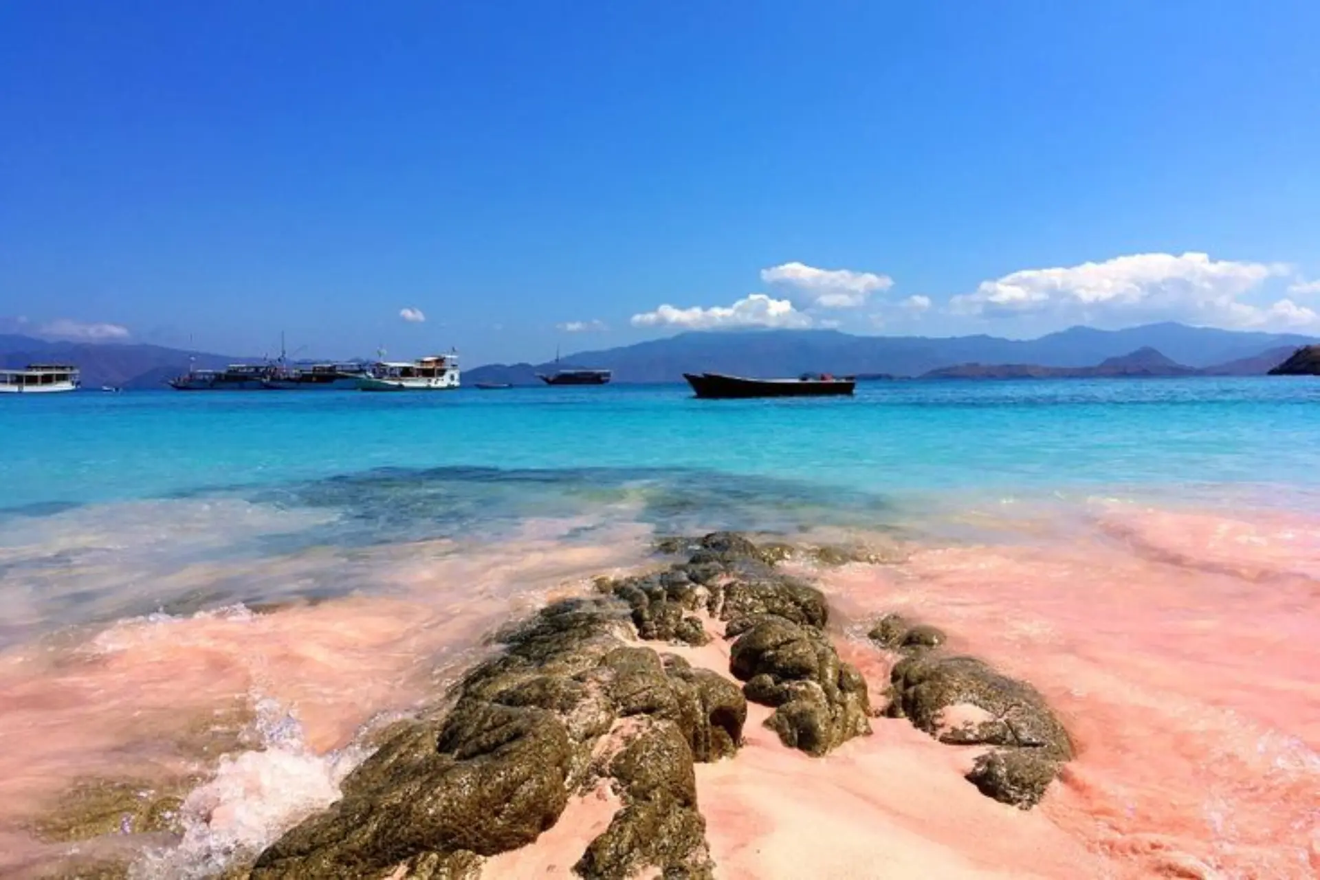 Boats anchored in blue water at Labuan Bajo beach