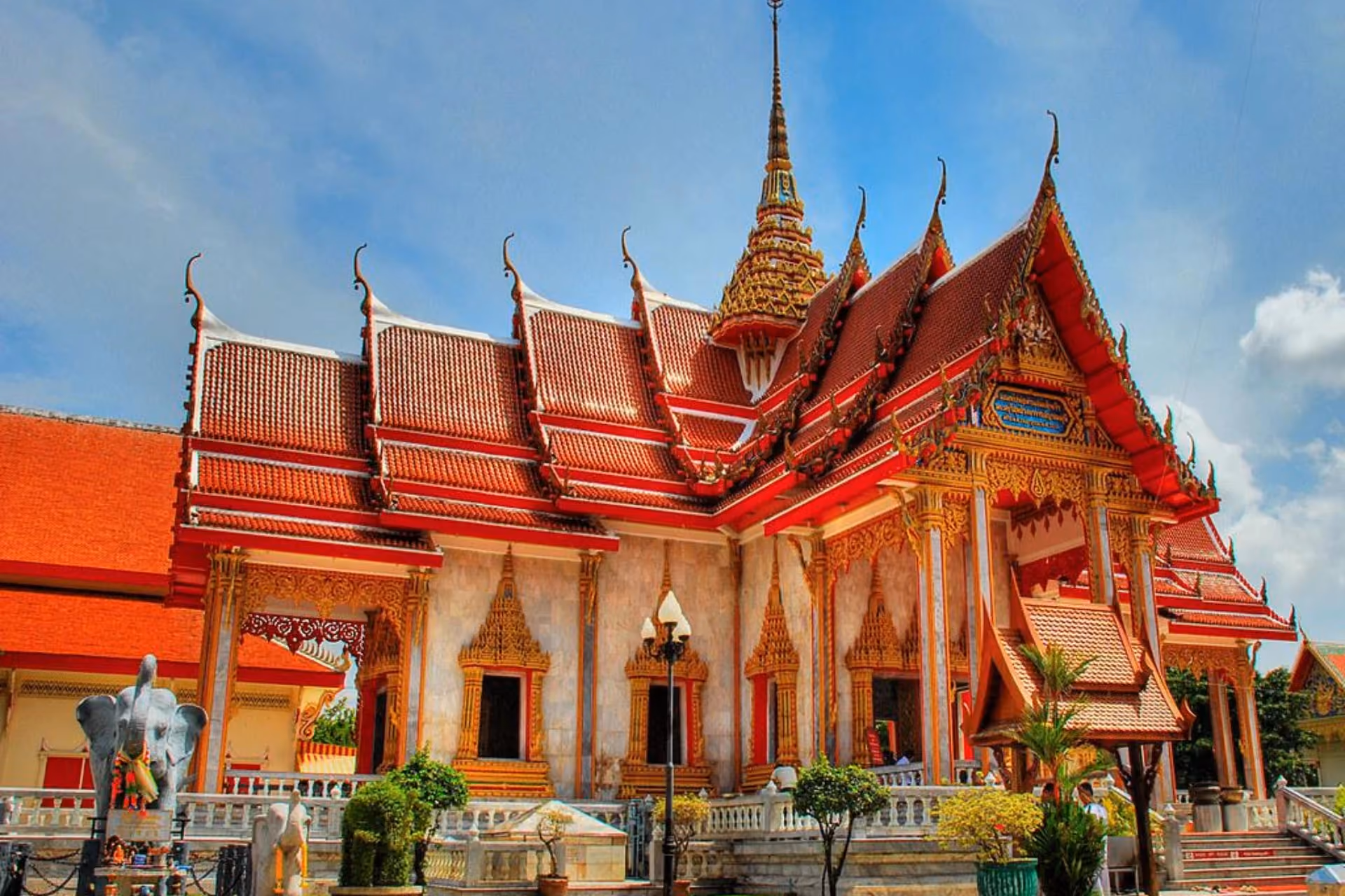 Chalong Temple with red roofs and gold decoration