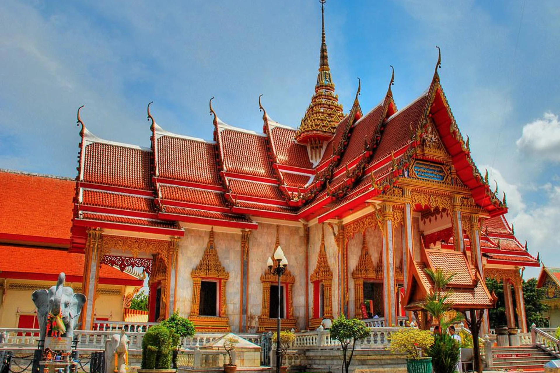 Chalong Temple with red roofs and gold decoration