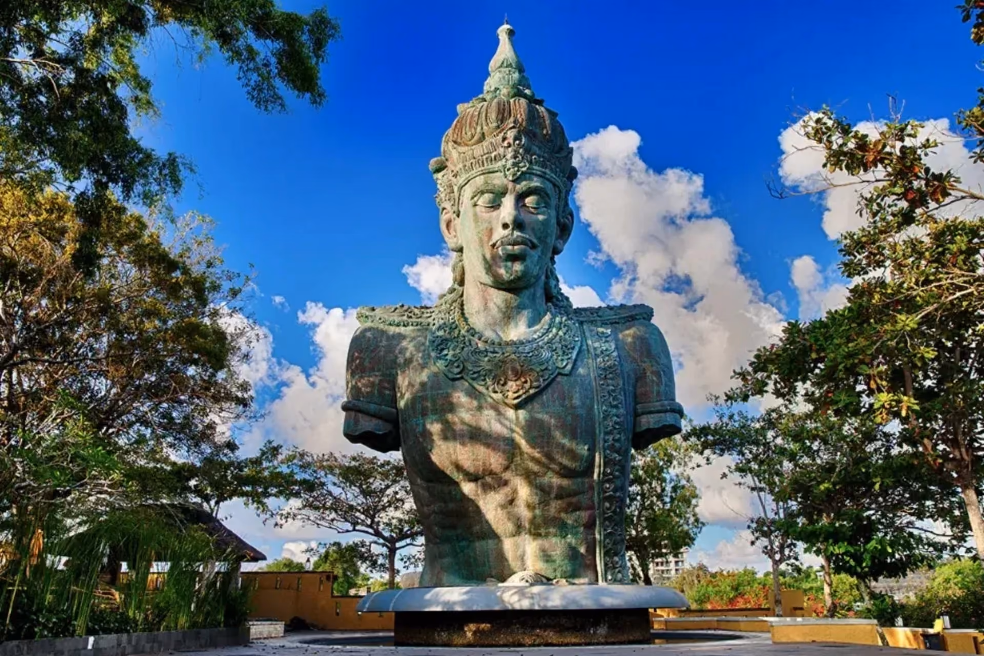 Giant stone statue with tall headdress at GWK Bali