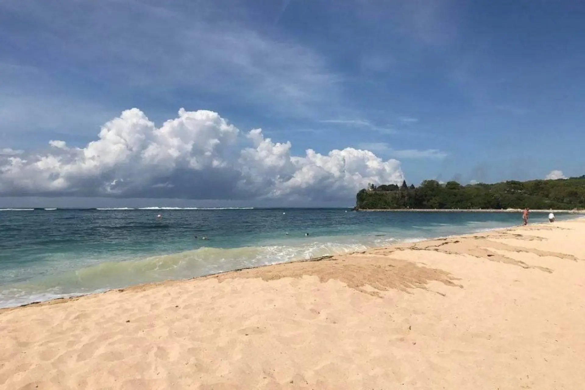 Sandy beach with calm blue water at Geger Beach