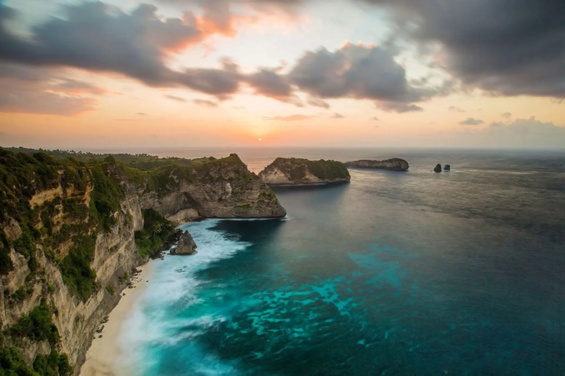 Steep cliffs and islands at Bali beach at sunset