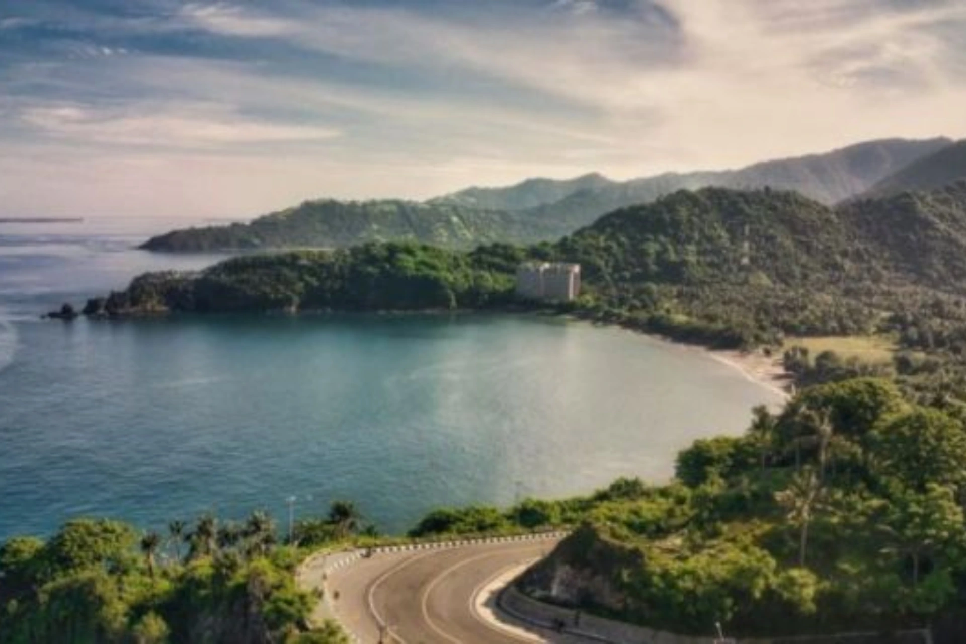 Curved road overlooking beach and hills at Malimbu Lombok