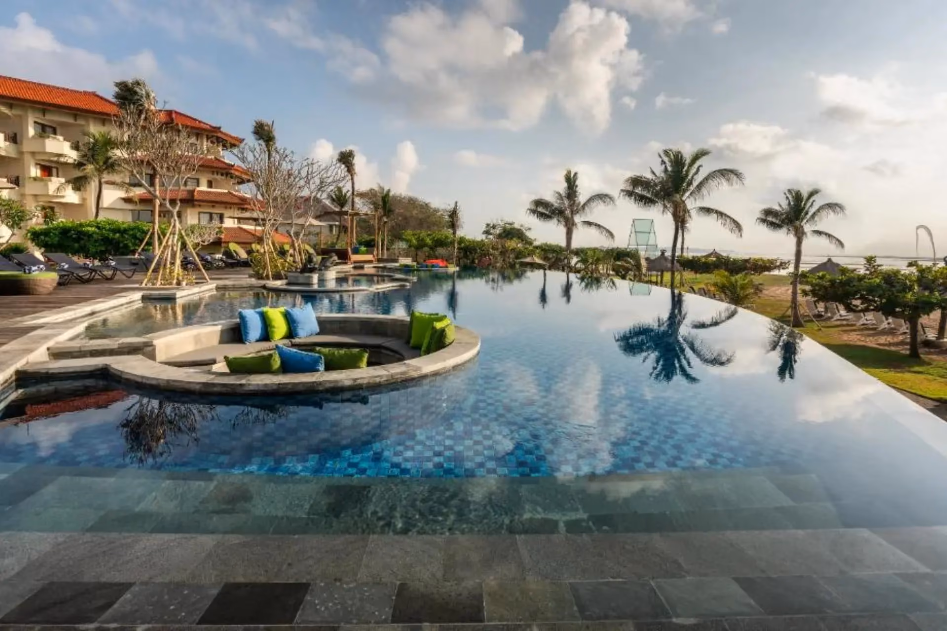 Grand Mirage resort pool with palm trees and lounging area