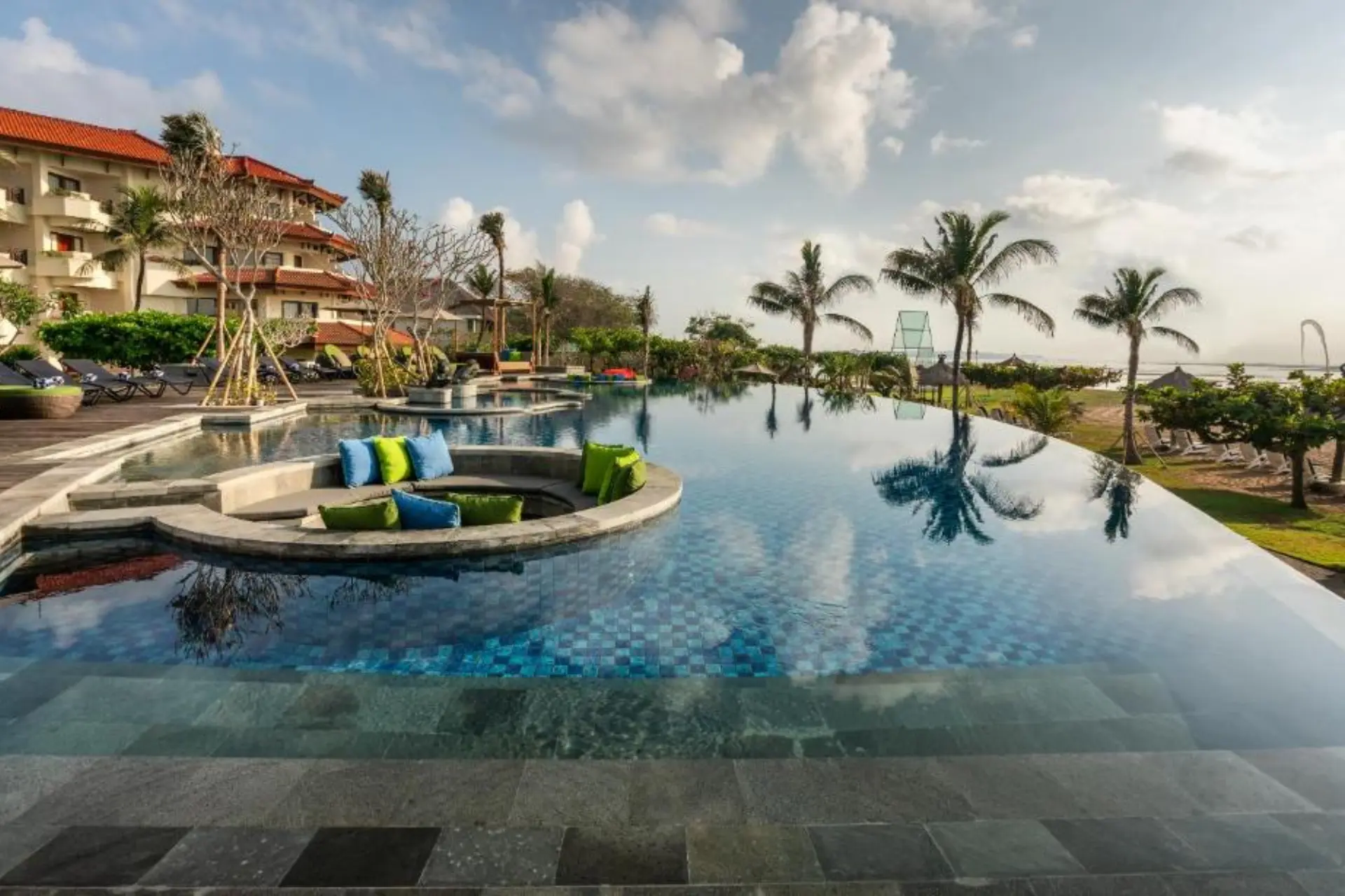 Grand Mirage resort pool with palm trees and lounging area
