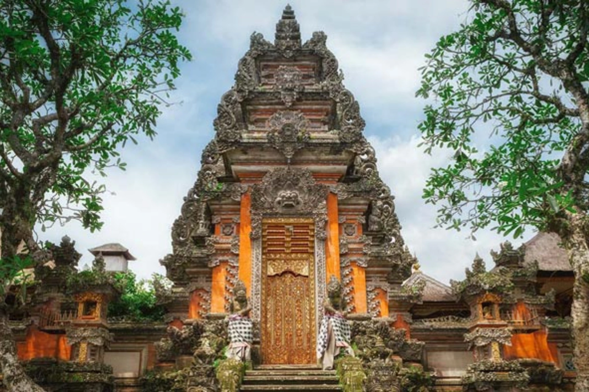 Ornate stone temple with gold door in Ubud