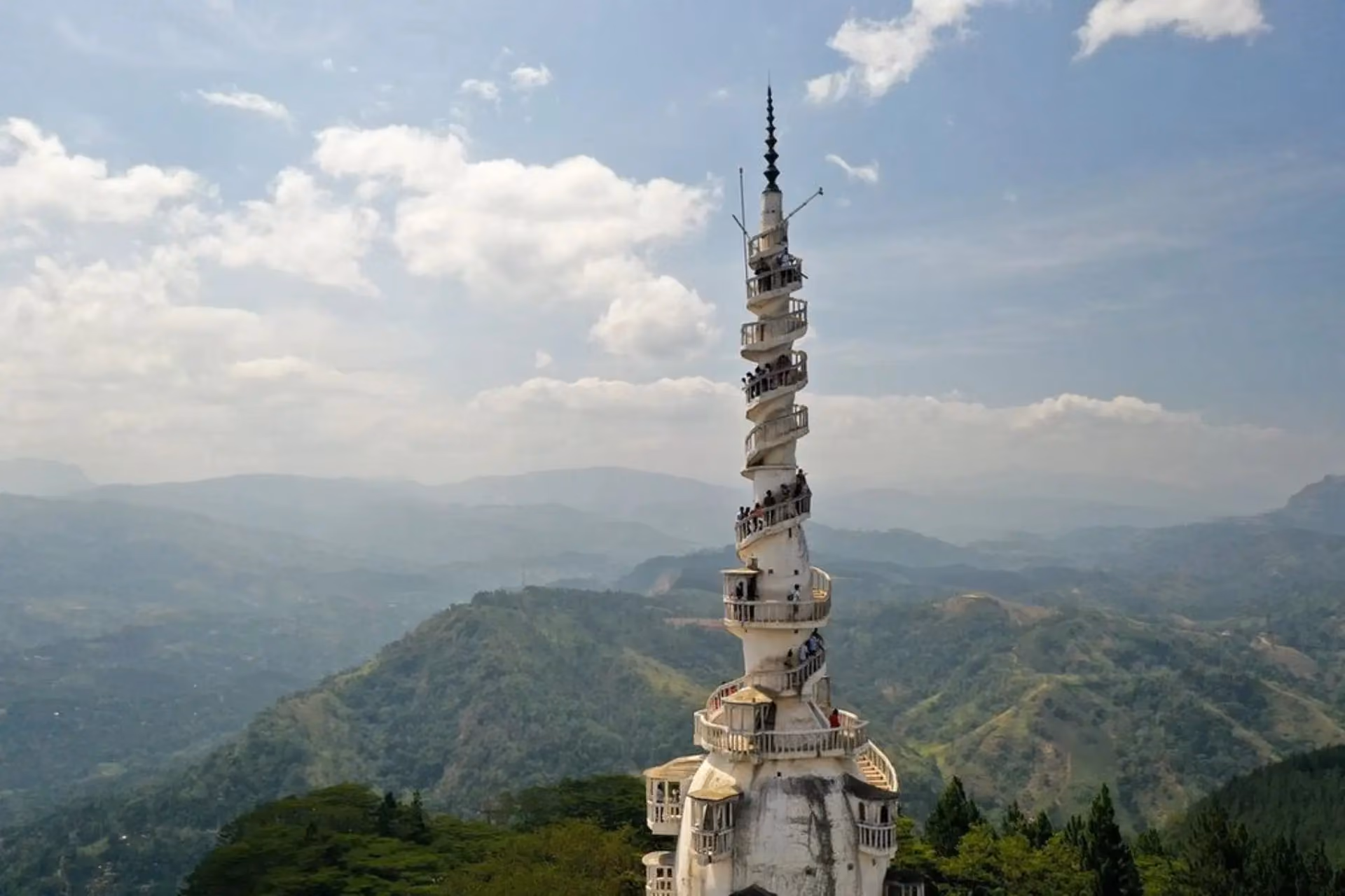 Ambulawa Tower spiraling up from green mountains