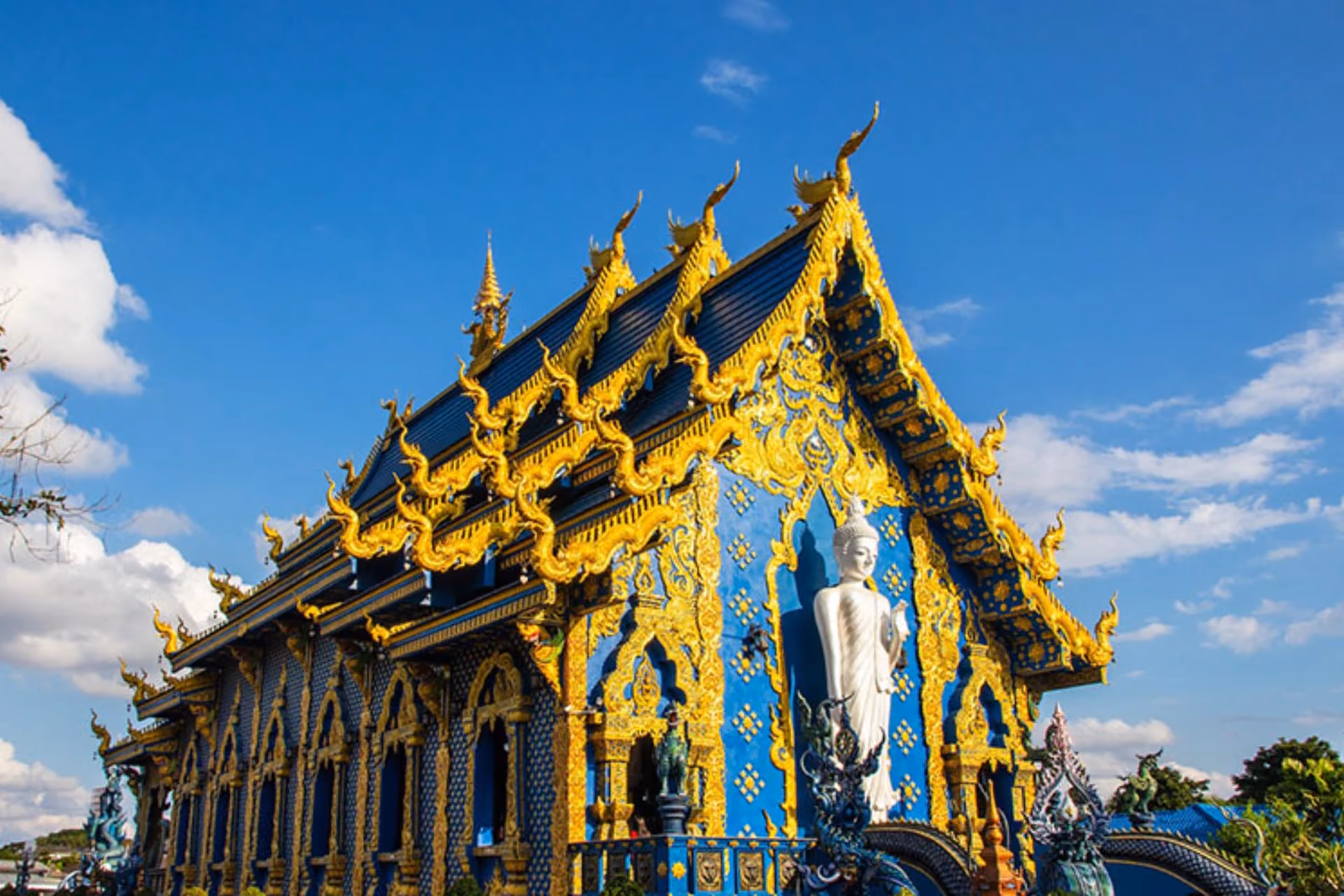Bright blue and gold temple with pointed roof, Chiang Mai