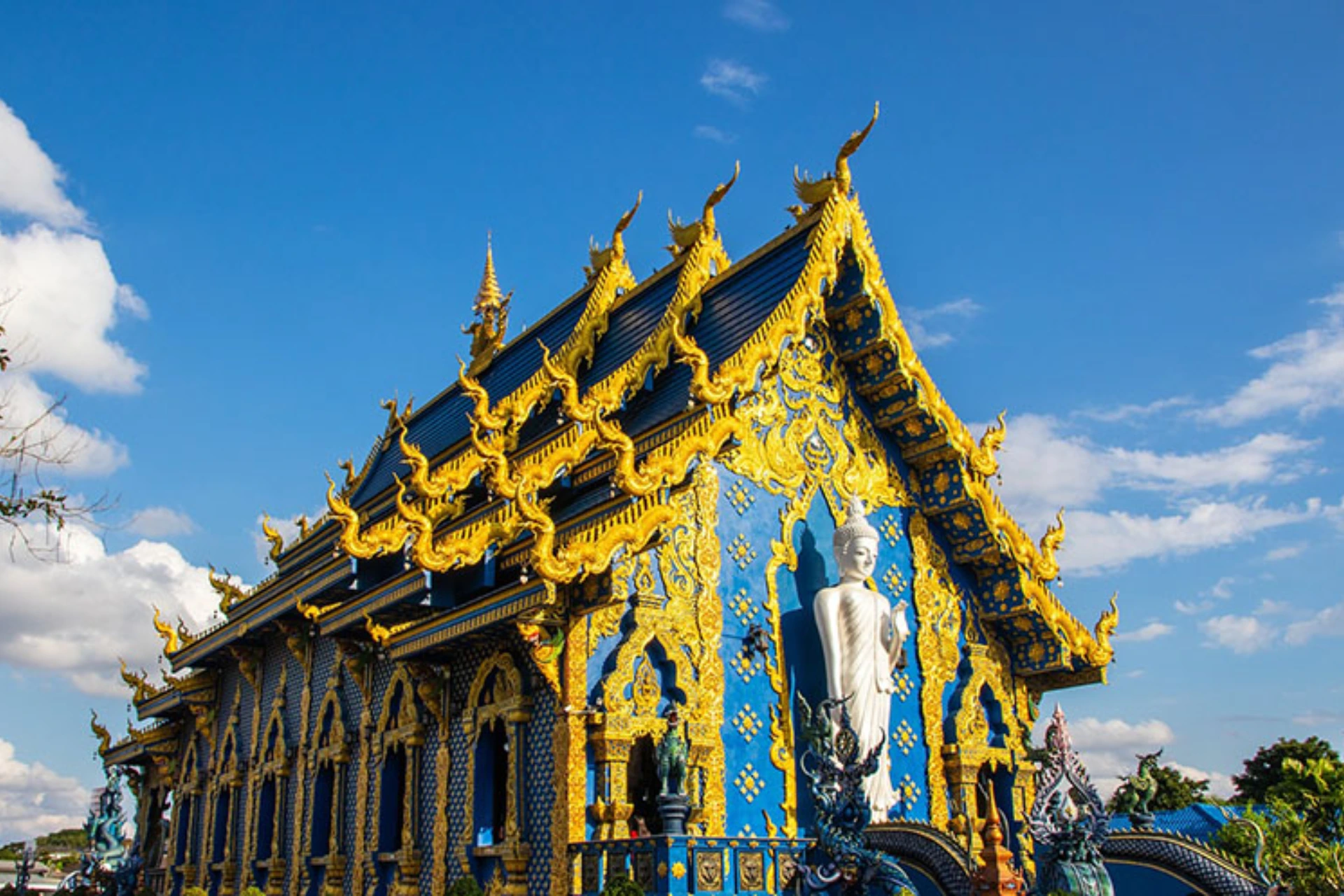 Bright blue and gold temple with pointed roof, Chiang Mai