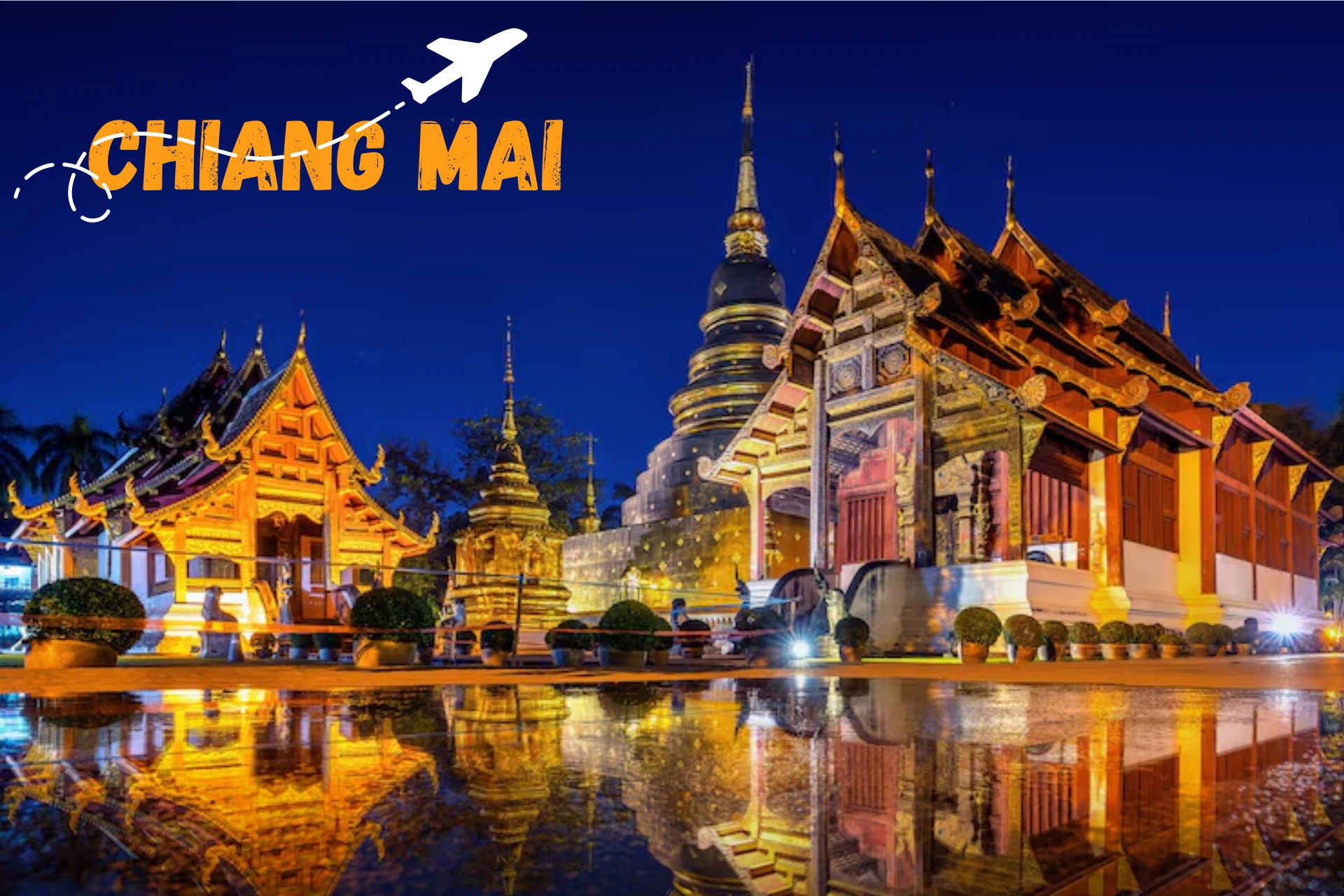 Lit temples reflected in water at night, Chiang Mai