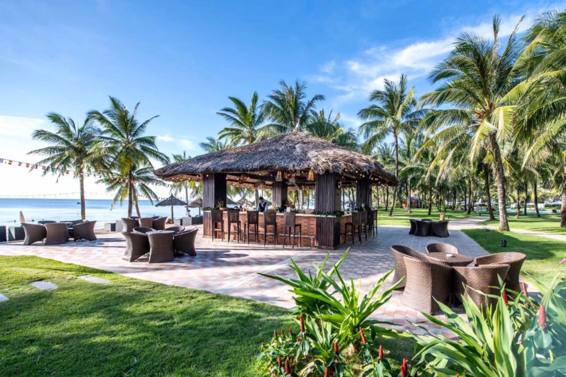 Vinepearl Phu Quoc beach bar with thatched roof and palm trees