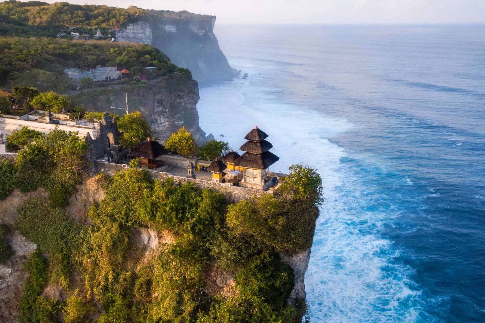 Uluwatu Temple on cliff edge overlooking ocean waves