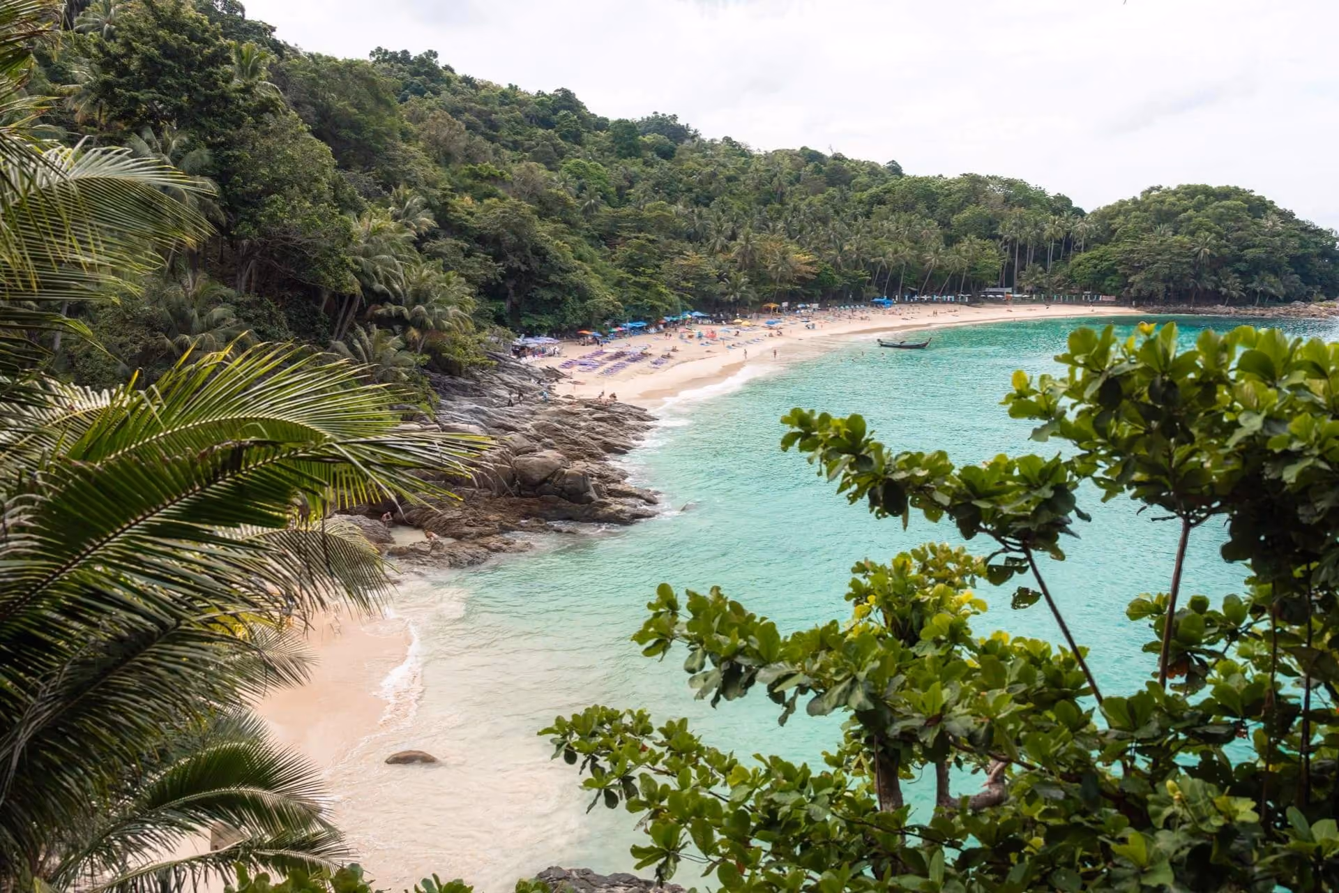 Freedom Beach with clear blue-green water and sandy shore