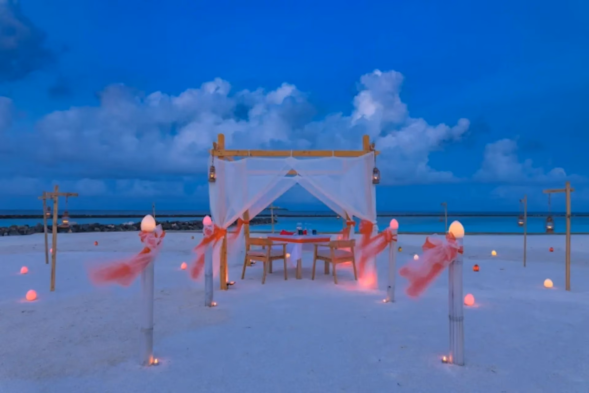 Beachside dinner setup at Sun Siyam Iru Veli at dusk