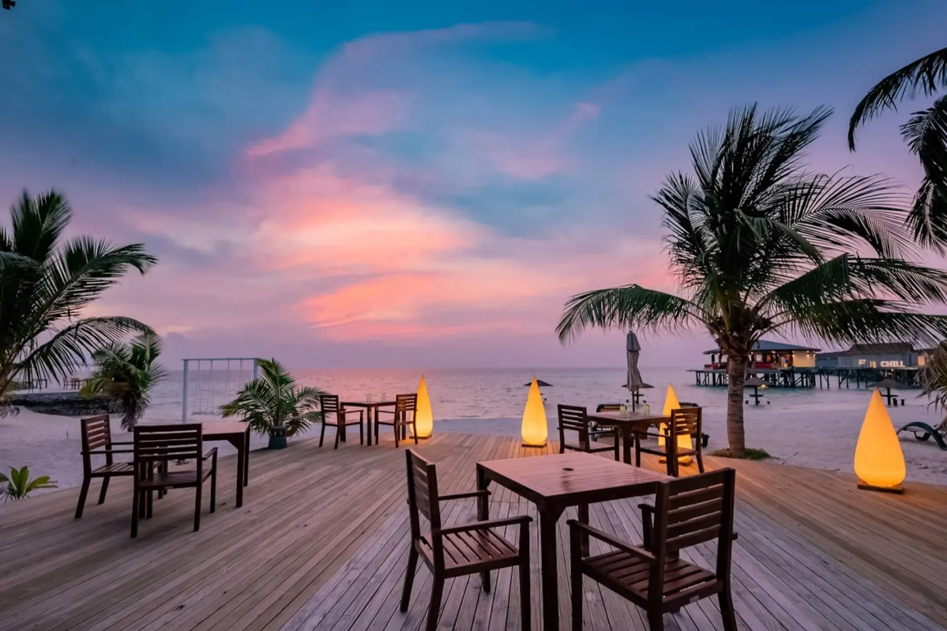 Centara Ras dining tables on beach at sunset
