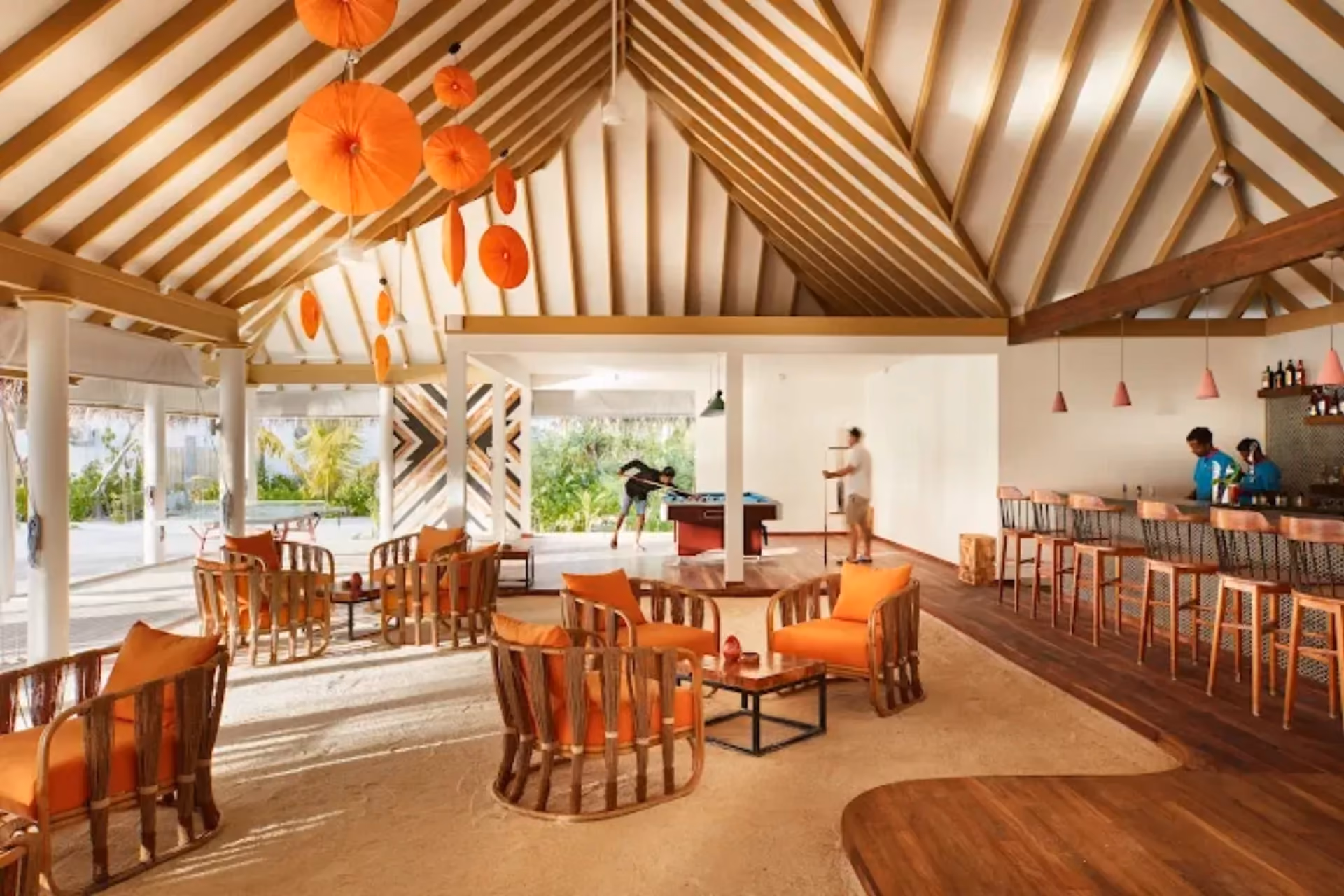 Sun Siyam Iru Veli indoor games room with orange chairs and decorations