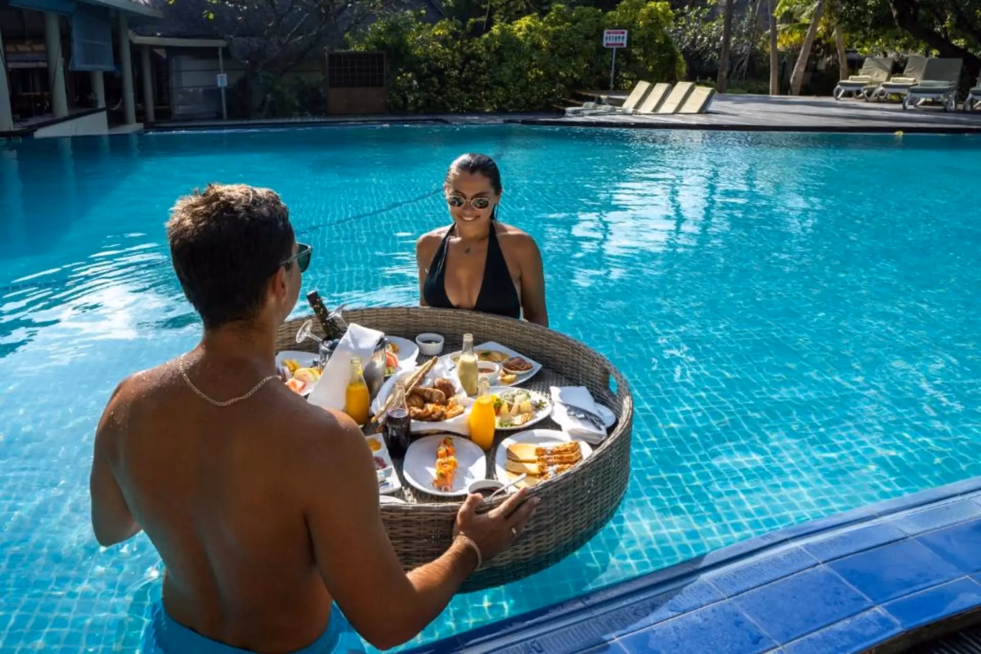 Couple enjoying meal in pool at Adaaran Select