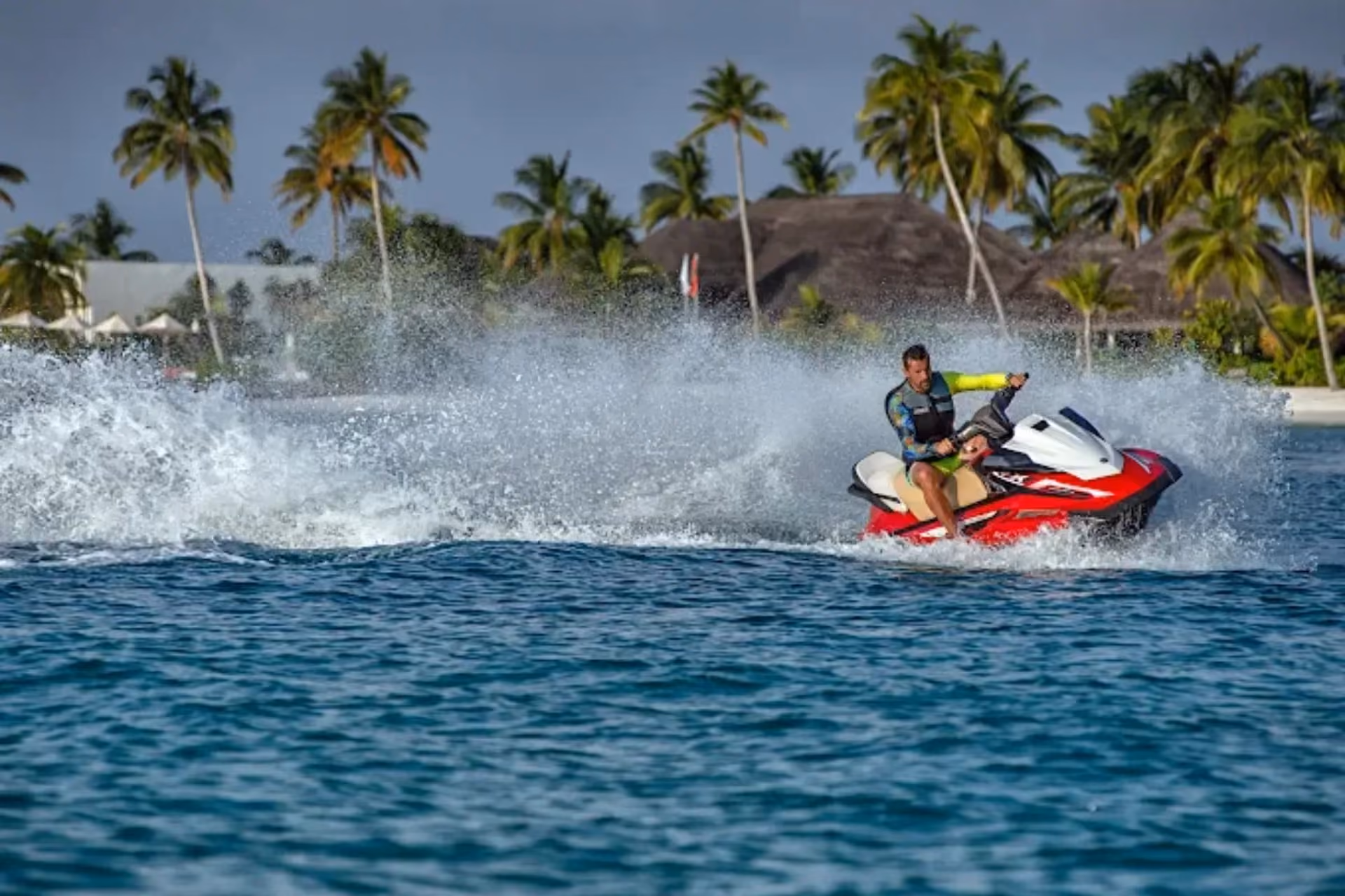 Person riding red jet ski at Sun Siyam Iru Veli resort