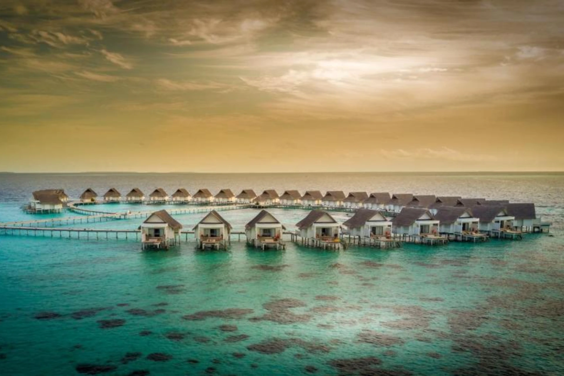 Centara Grand overwater bungalows in clear blue-green water