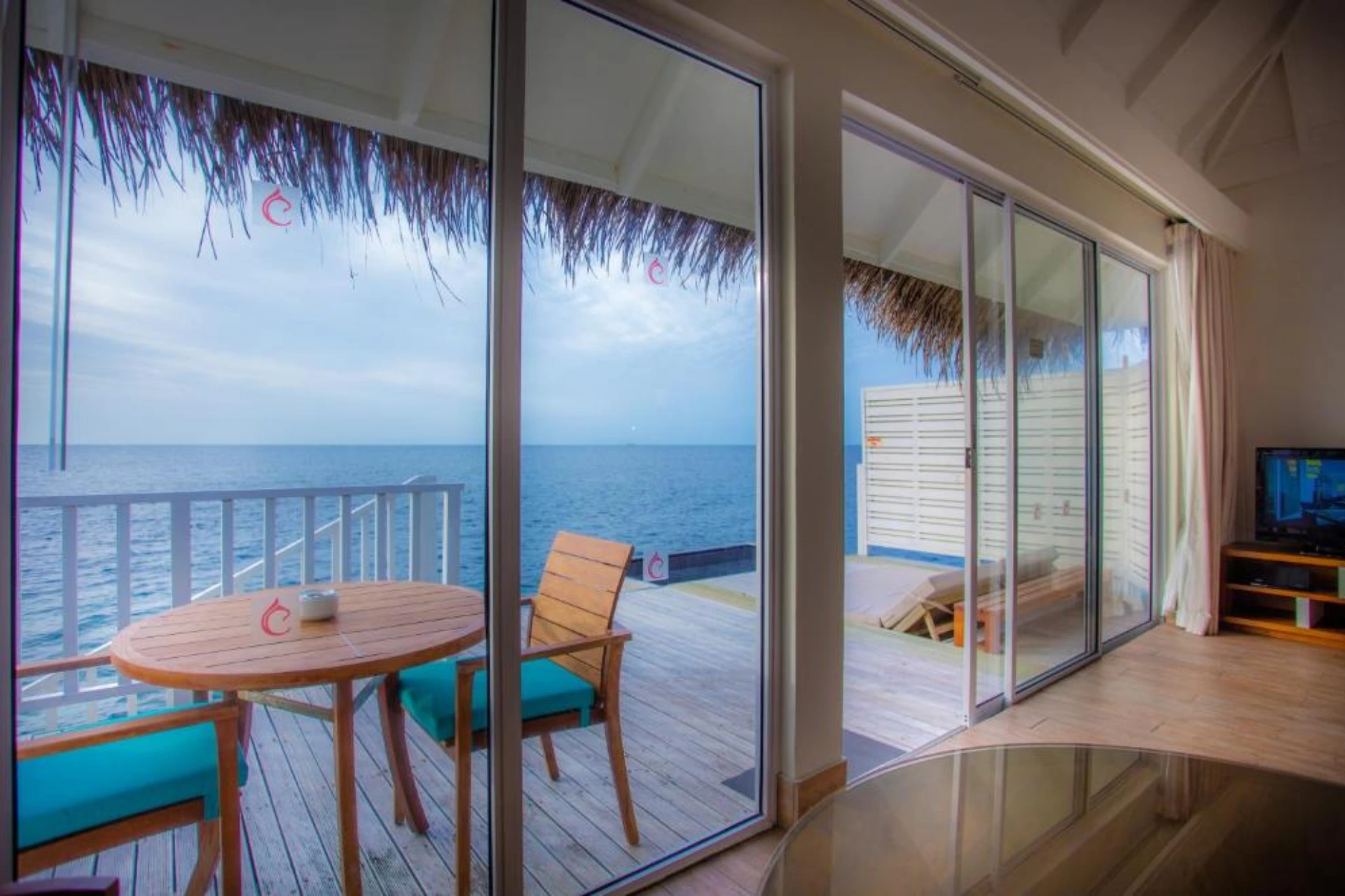 Centara Grand ocean view room with wooden deck and dining table