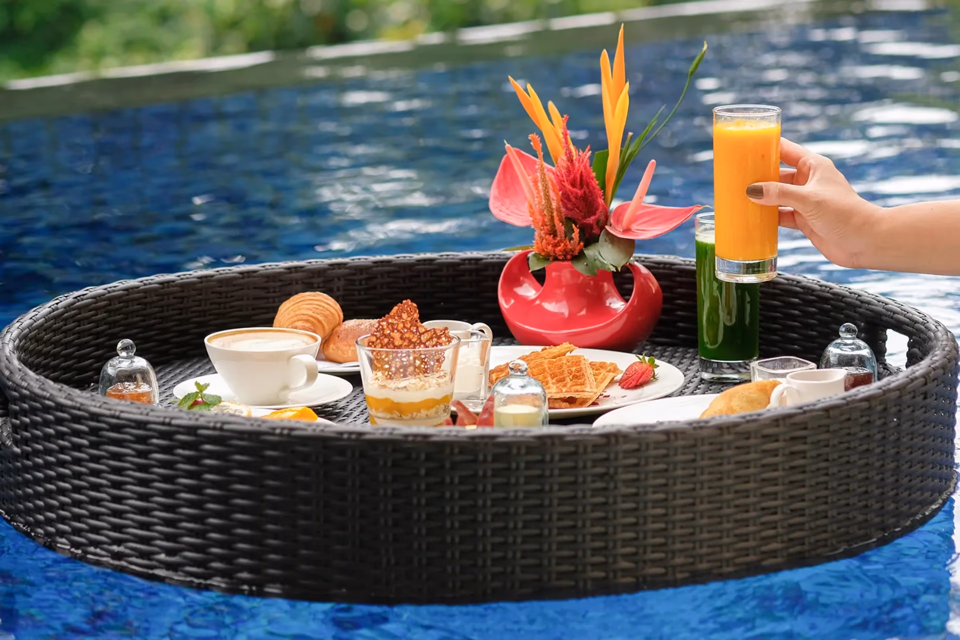 Floating breakfast in pool with orange juice and pastries