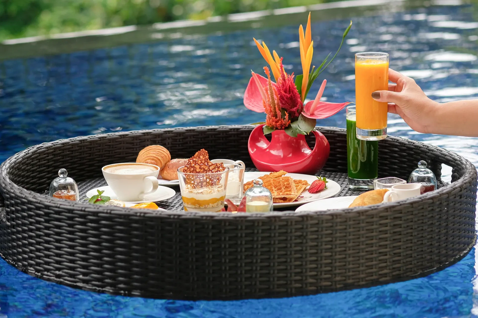 Floating breakfast in pool with orange juice and pastries