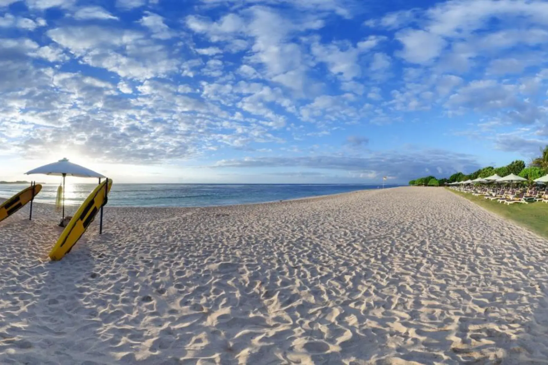 Wide sandy beach at Ayodya with blue sky and water