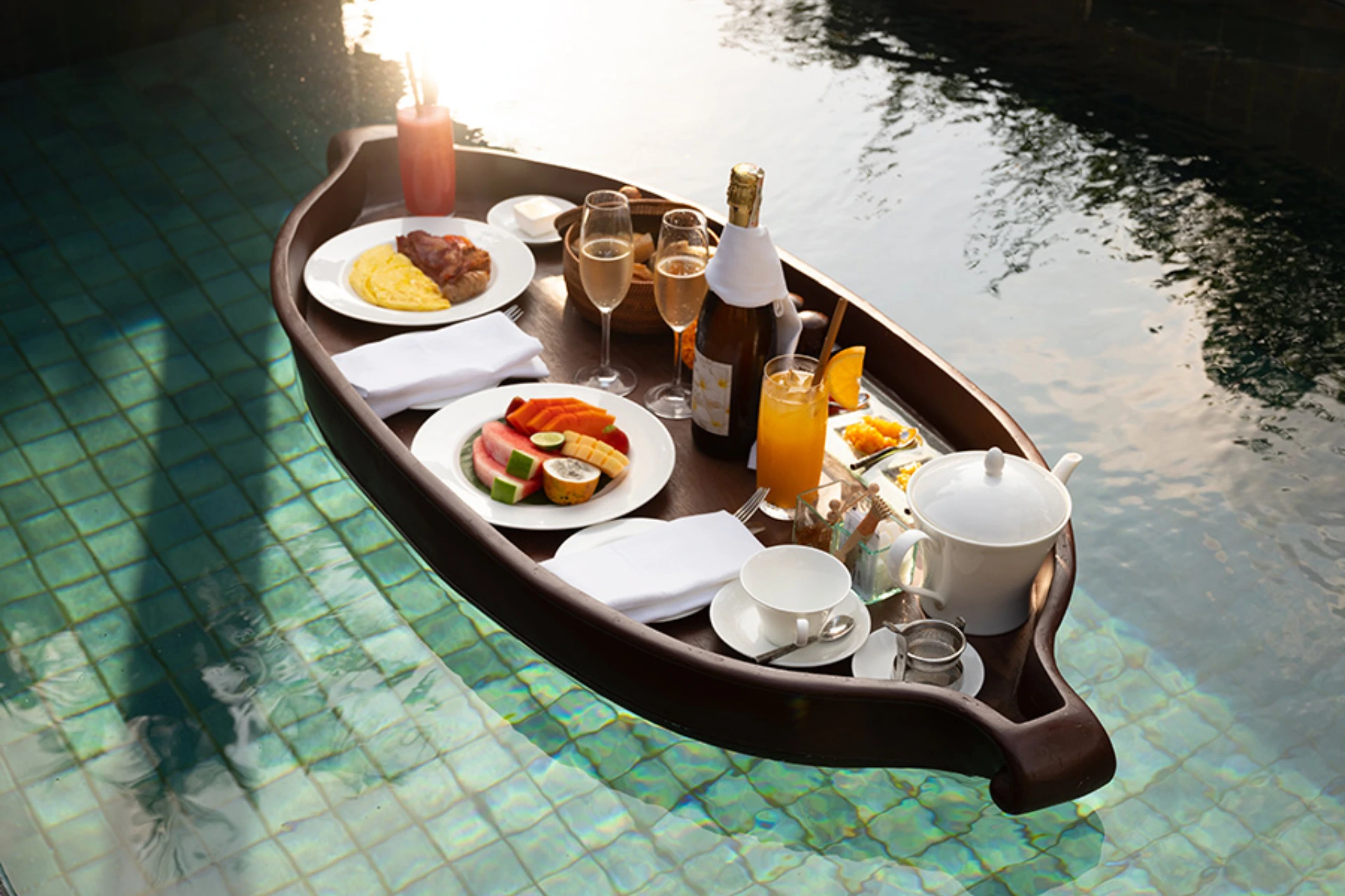 Boat with breakfast food floating in clear water