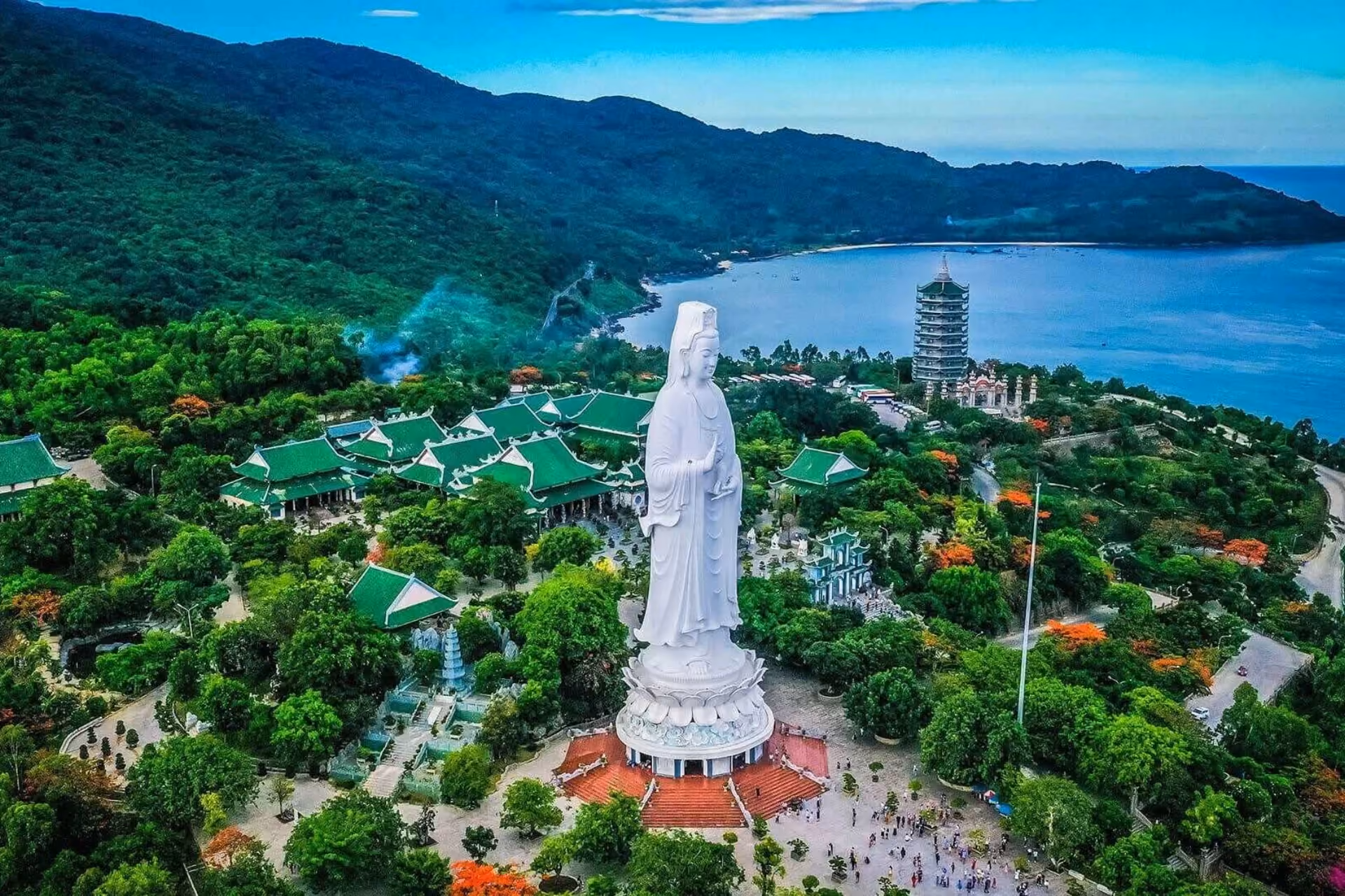 White statue overlooking temple and bay at Son Tra Peninsula
