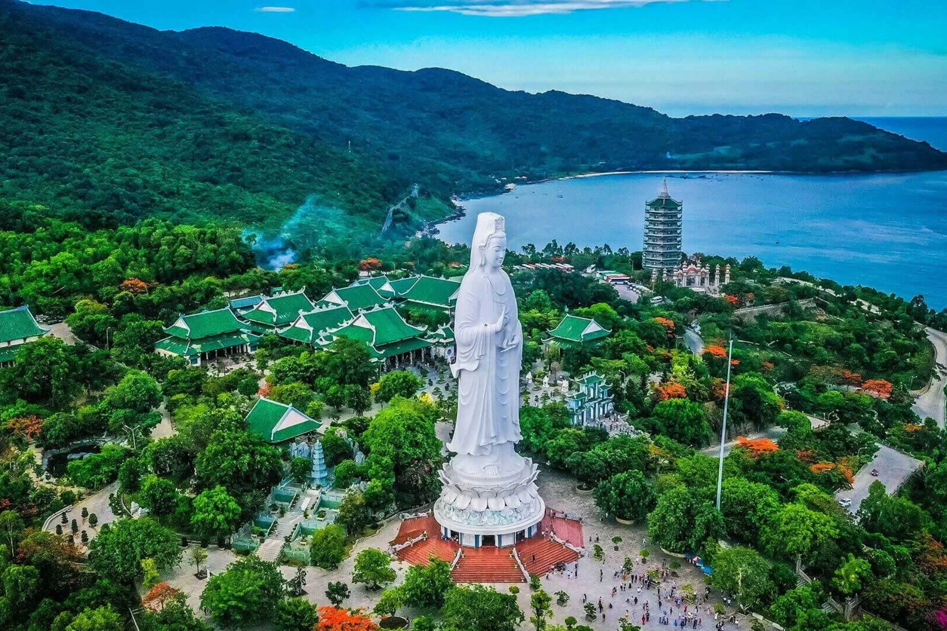 White statue overlooking temple and bay at Son Tra Peninsula
