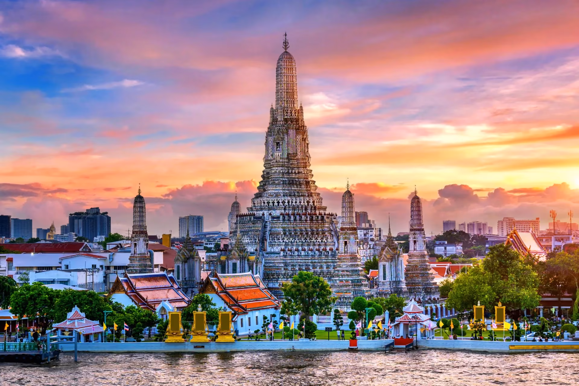 Wat Arun temple with golden spires at sunset Bangkok