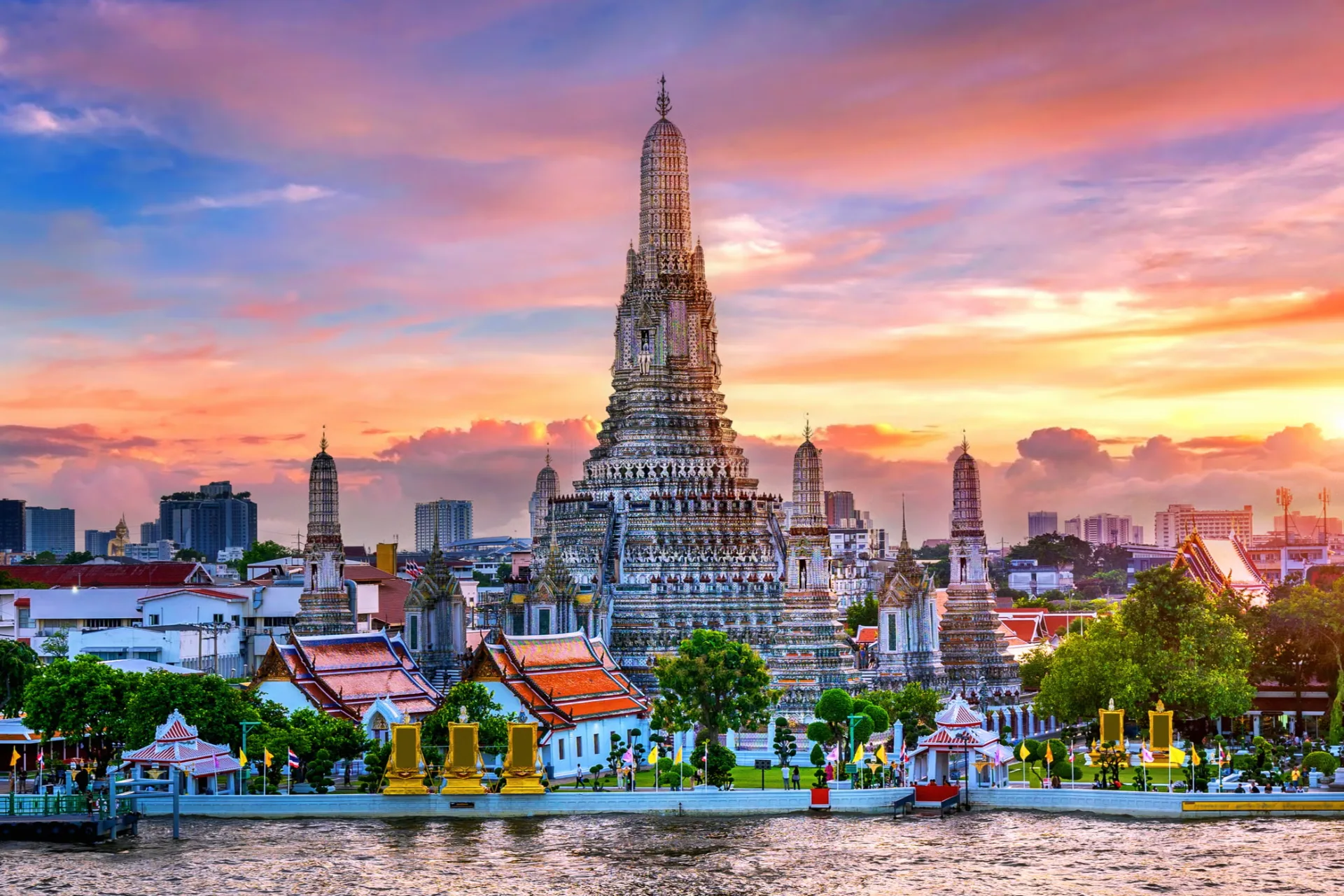 Wat Arun temple with golden spires at sunset Bangkok