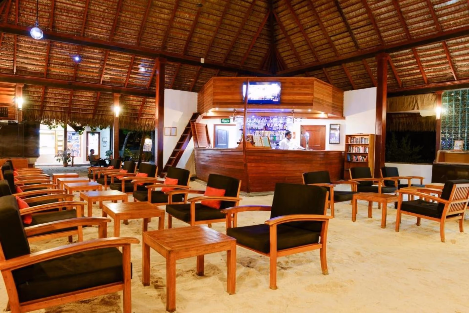 Adaaran Rannalhi beach bar with wooden furniture and sand floor