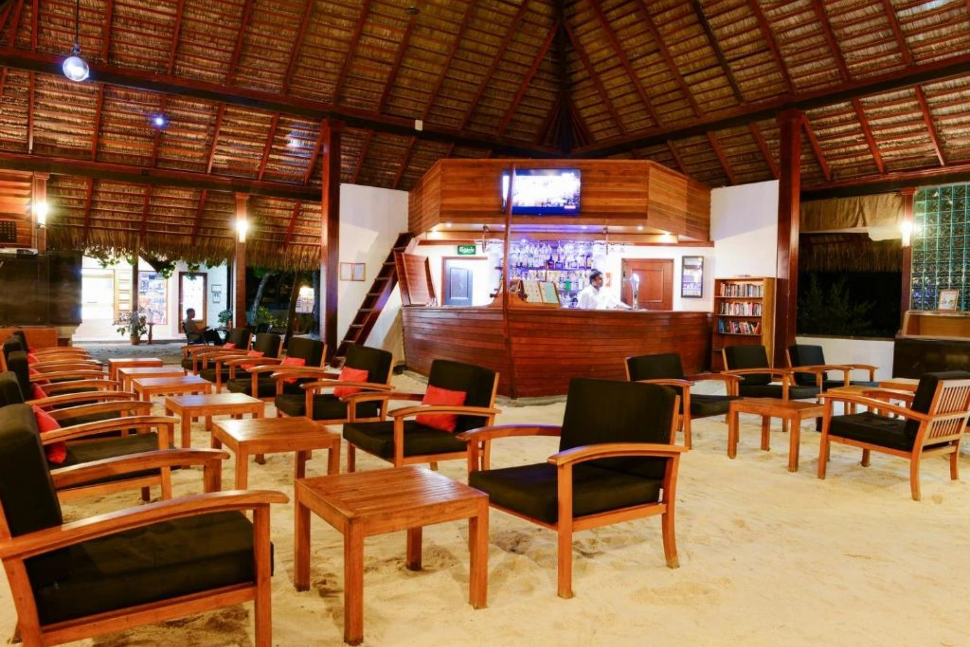 Adaaran Rannalhi beach bar with wooden furniture and sand floor