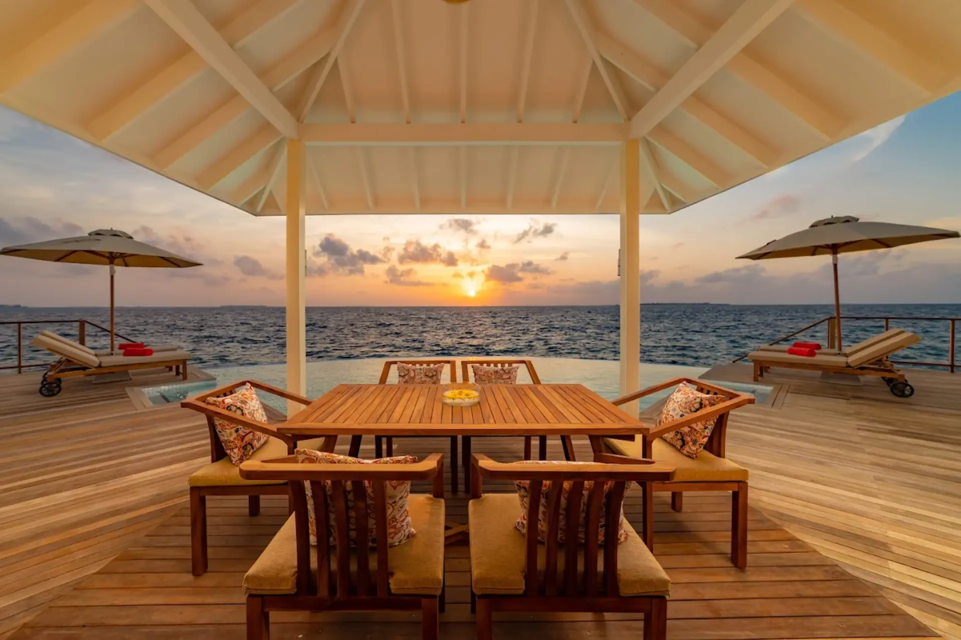 Siyam World beach dining area at sunset over the ocean