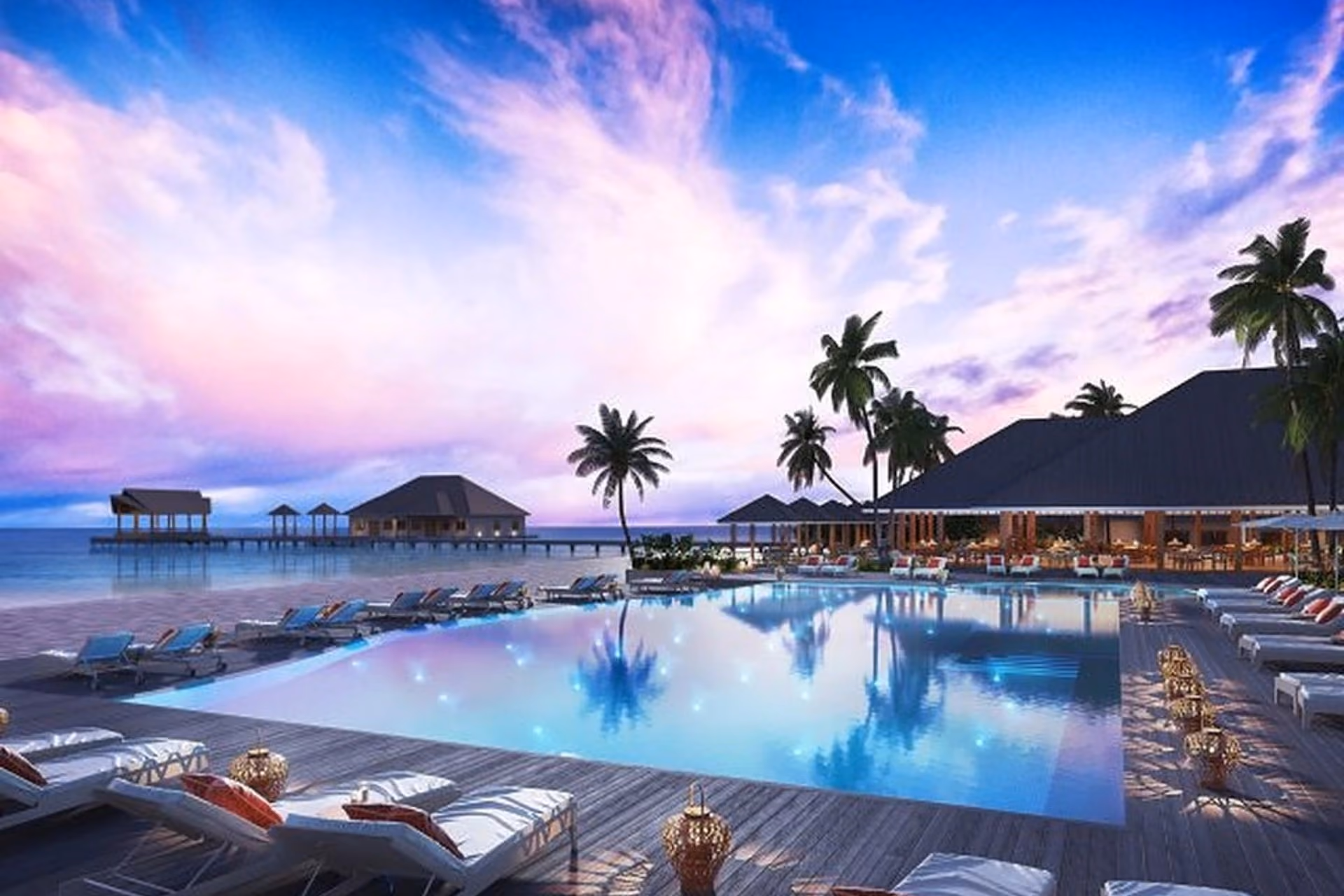 Brennia Kottefaru resort pool at sunset with palm trees and ocean bungalows