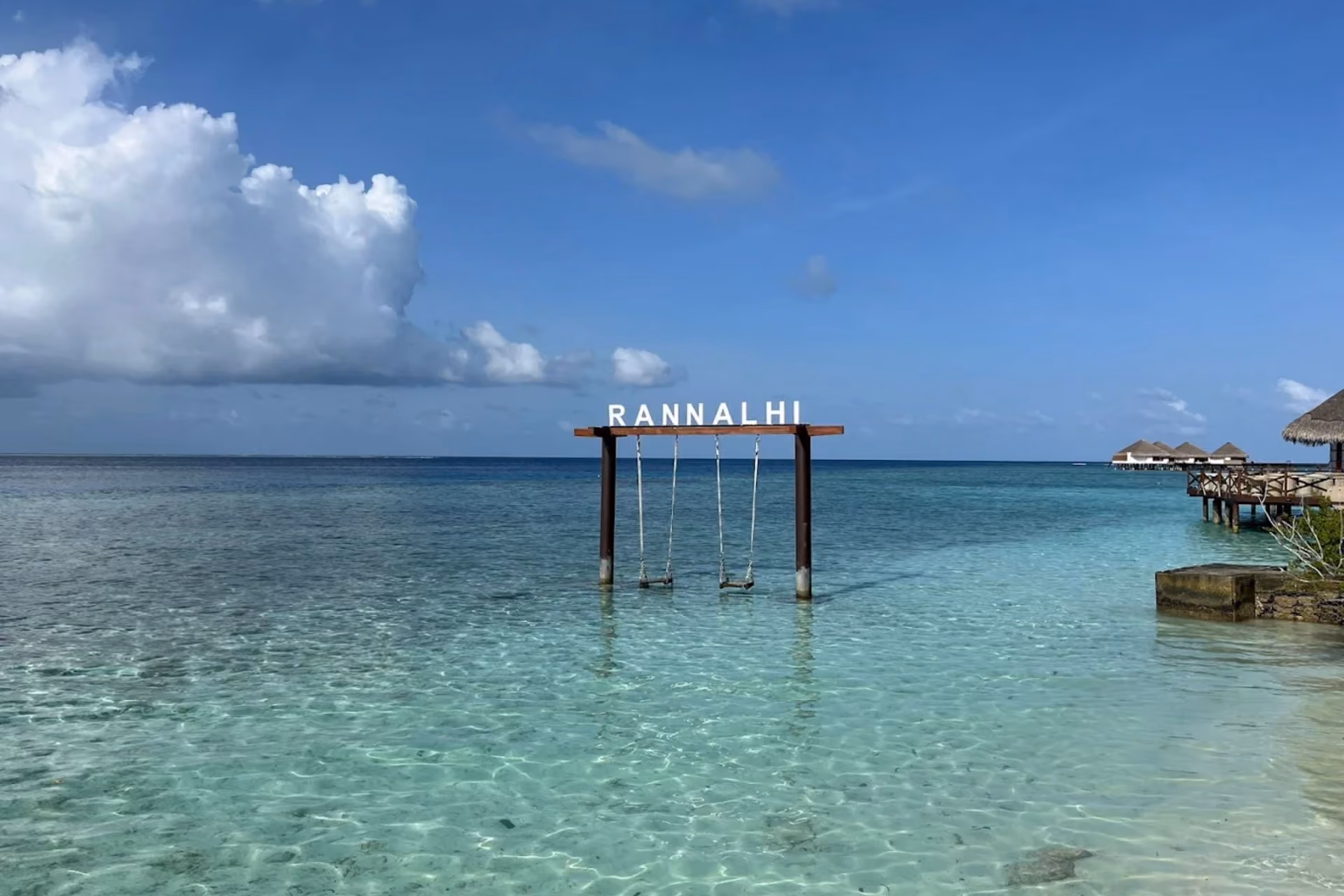 Wooden swing with four seats in clear water at Rannalhi