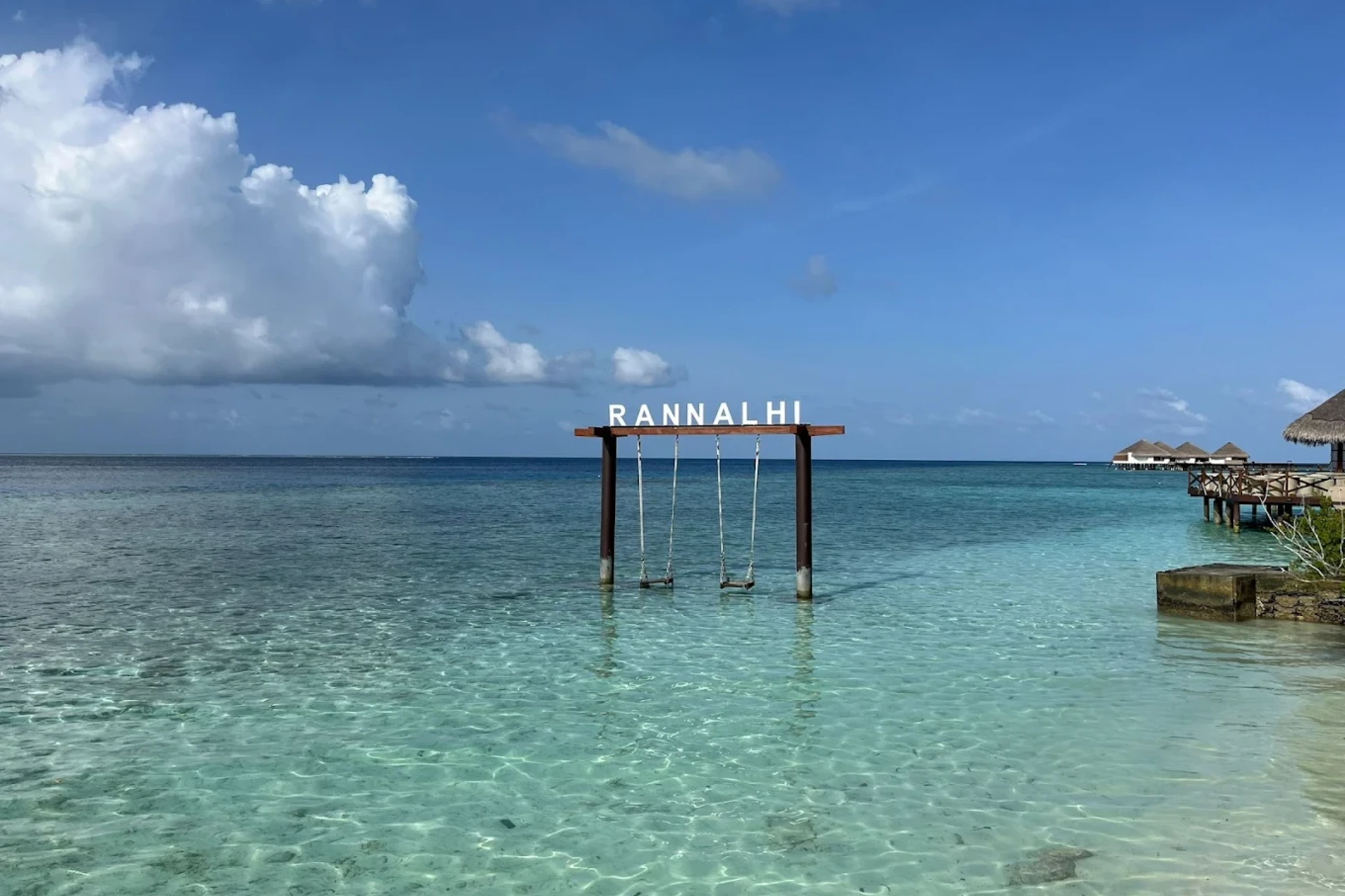 Wooden swing with four seats in clear water at Rannalhi
