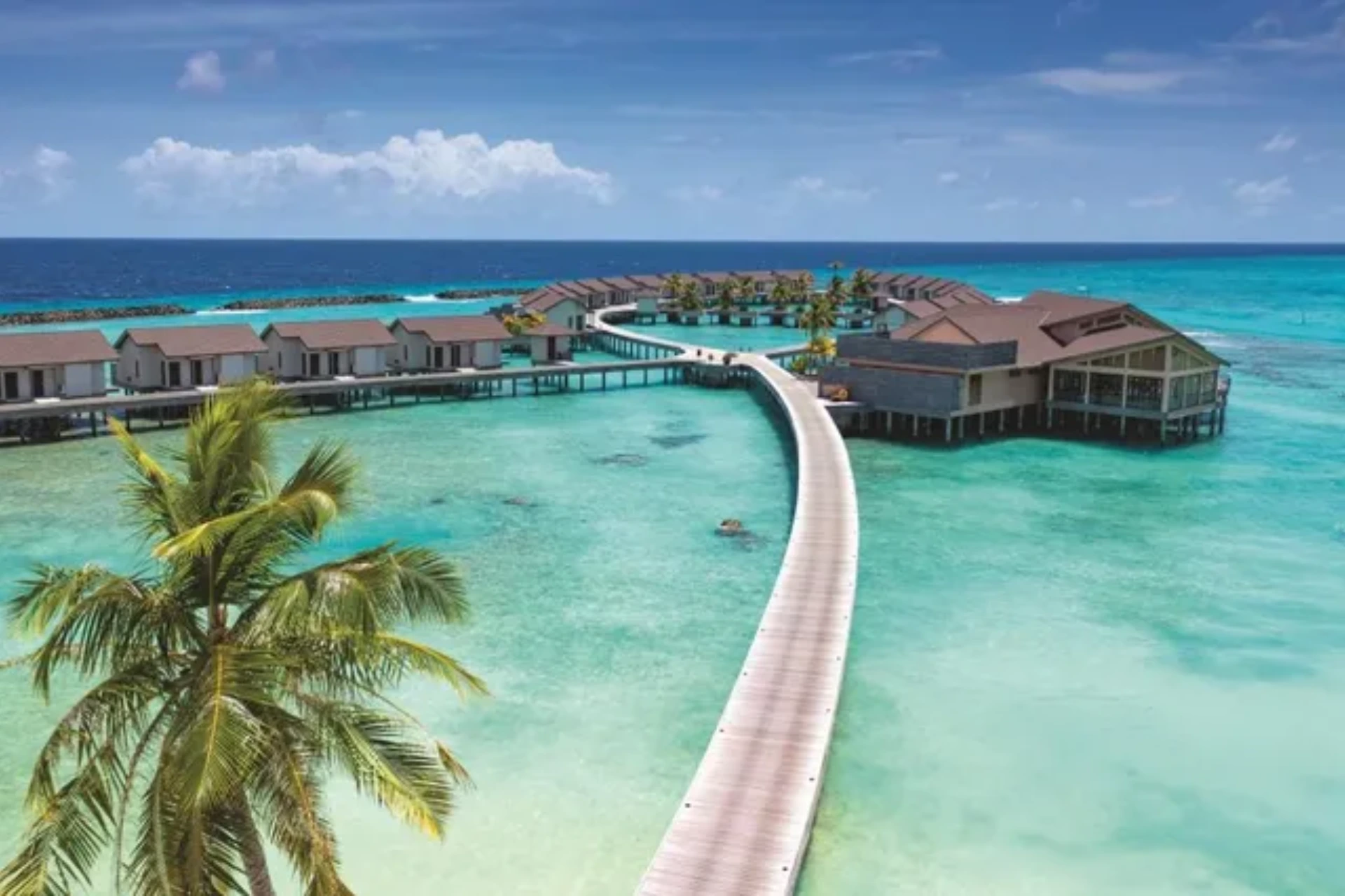 Atmosphere Kanifushi overwater bungalows in clear blue water
