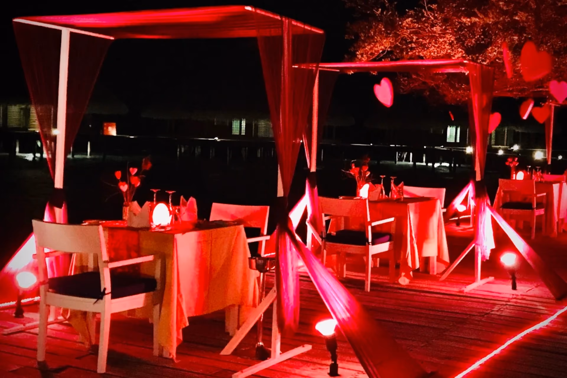 Adaaran Rannalhi outdoor dining area lit in red at night