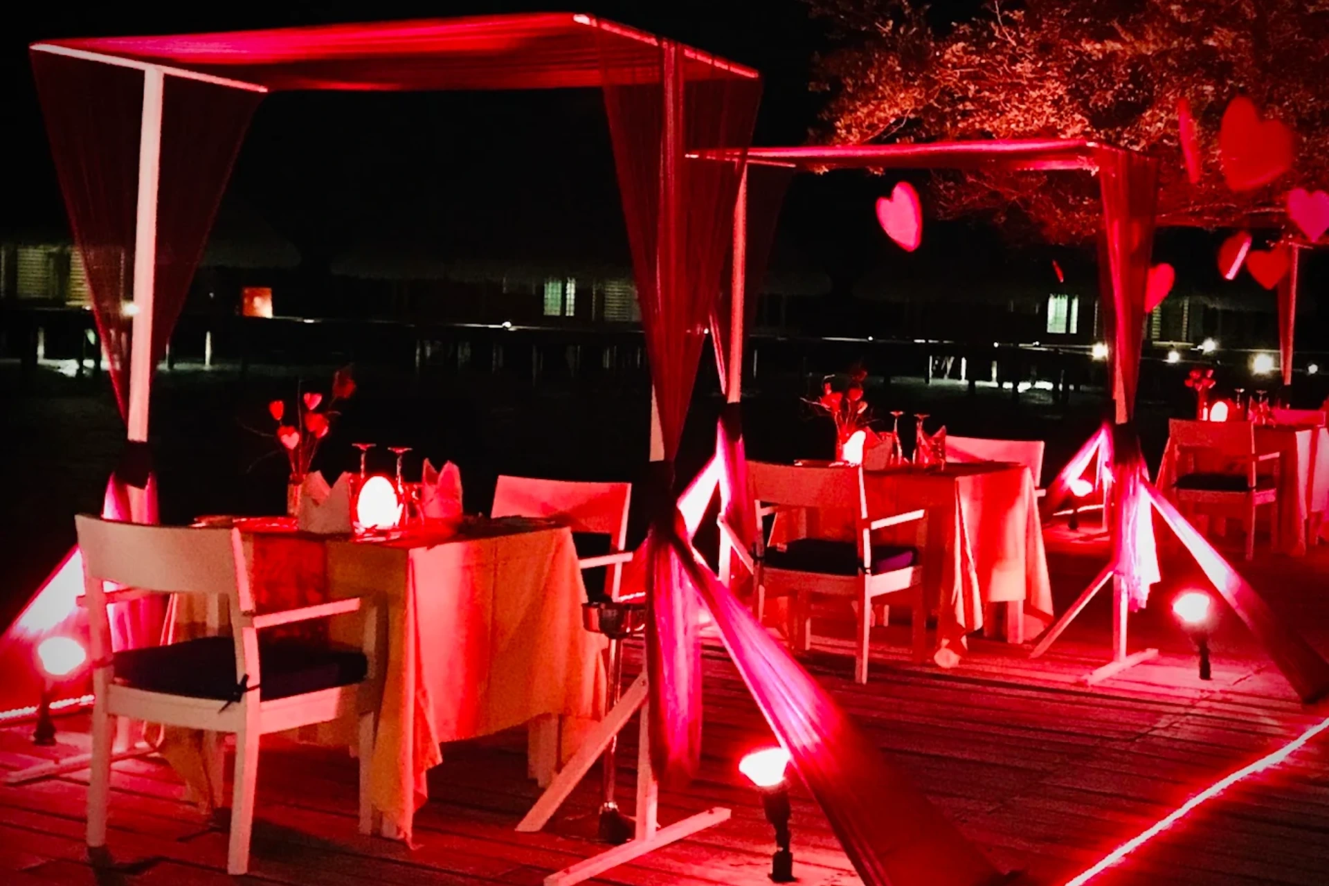 Adaaran Rannalhi outdoor dining area lit in red at night