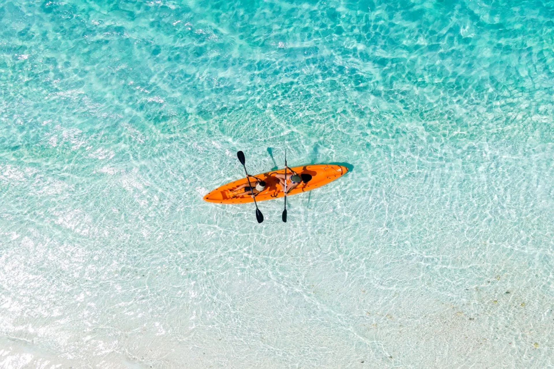 Orange kayak in clear blue-green water at Holiday Inn Resort