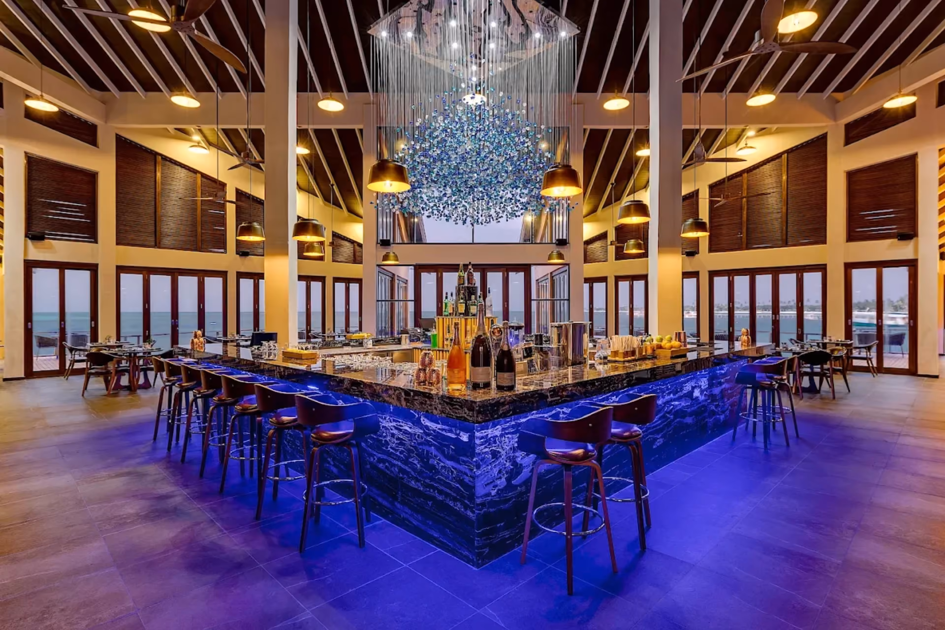 Atmosphere Kanifushi Bar with blue lighting and ocean views
