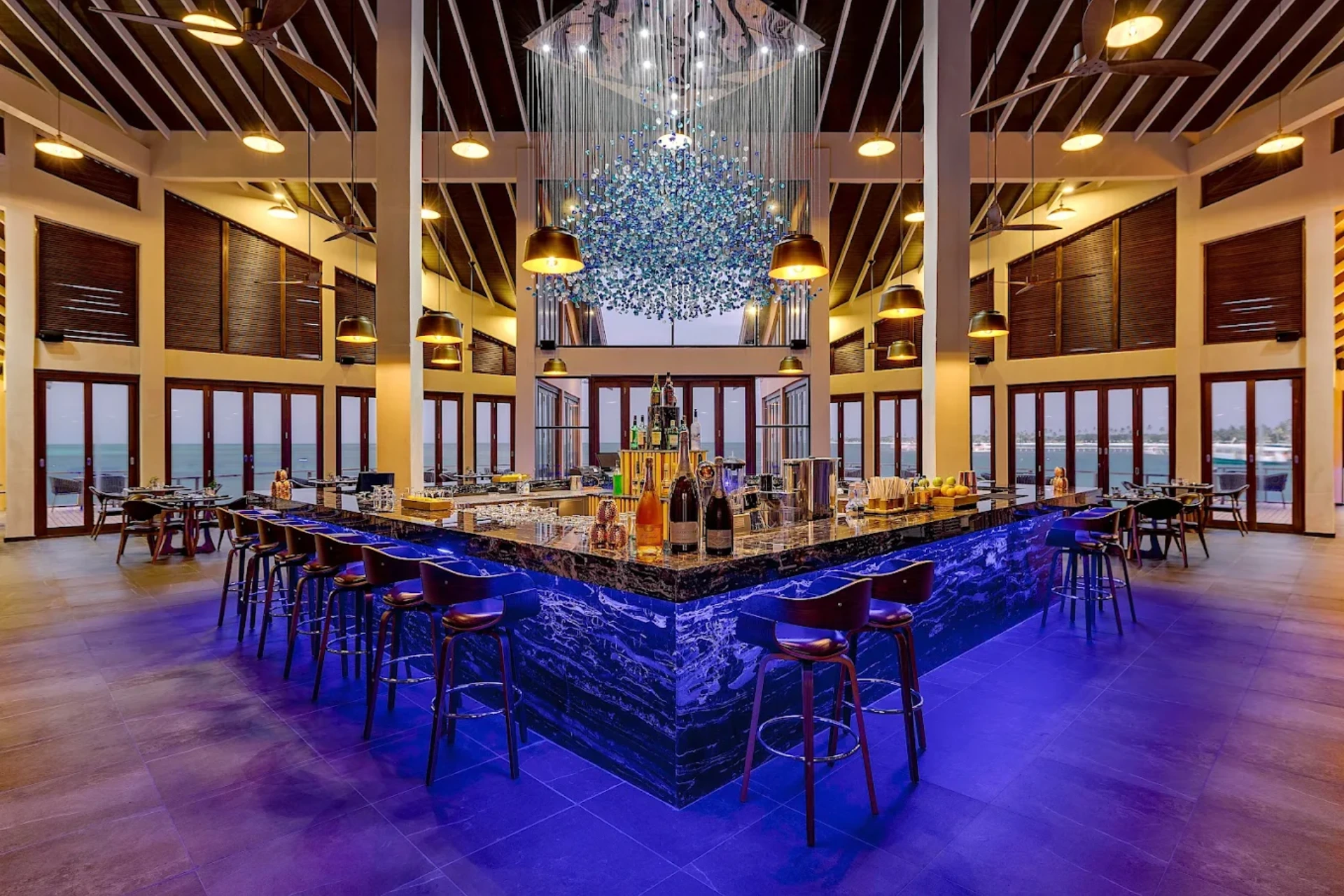 Atmosphere Kanifushi Bar with blue lighting and ocean views