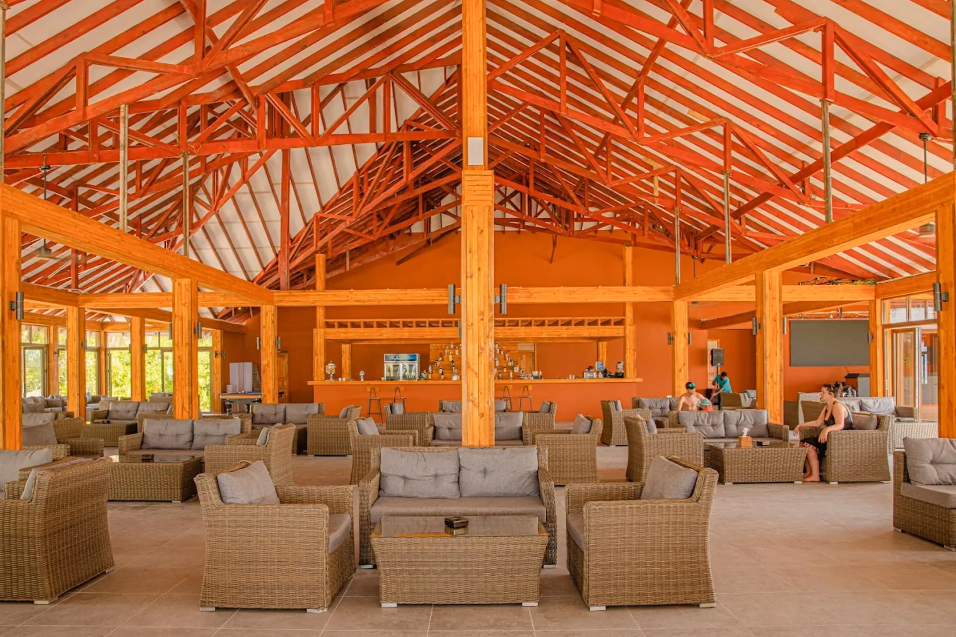 Brennia Kottefaru dining hall with wicker chairs and orange walls
