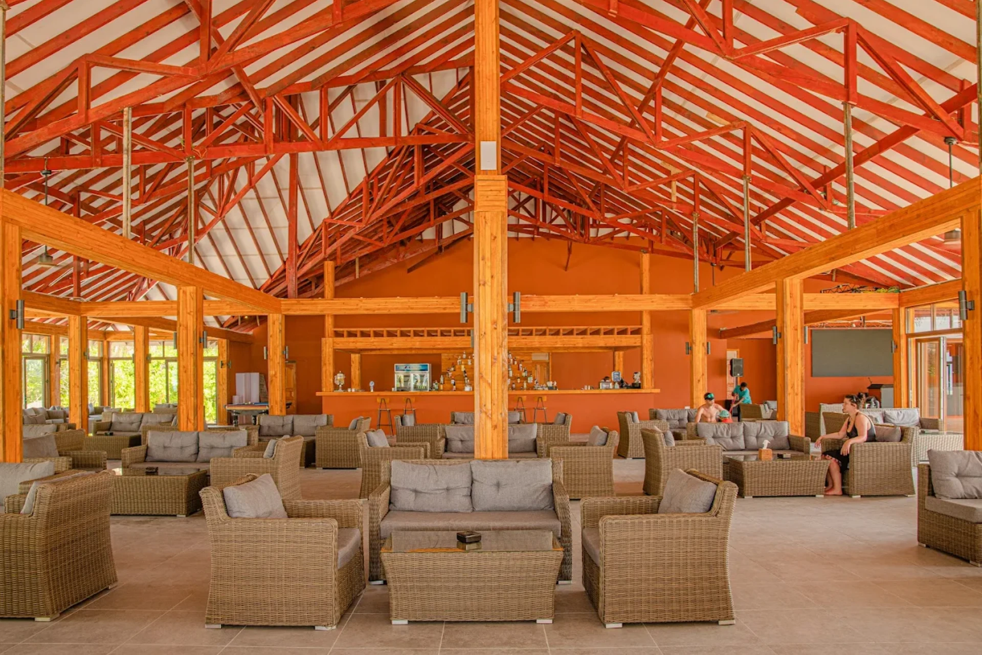 Brennia Kottefaru dining hall with wicker chairs and orange walls