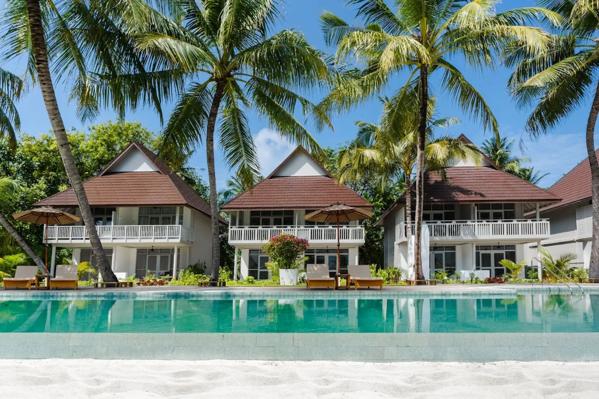 Sun Siyam Resort beachfront villas with pool and palm trees