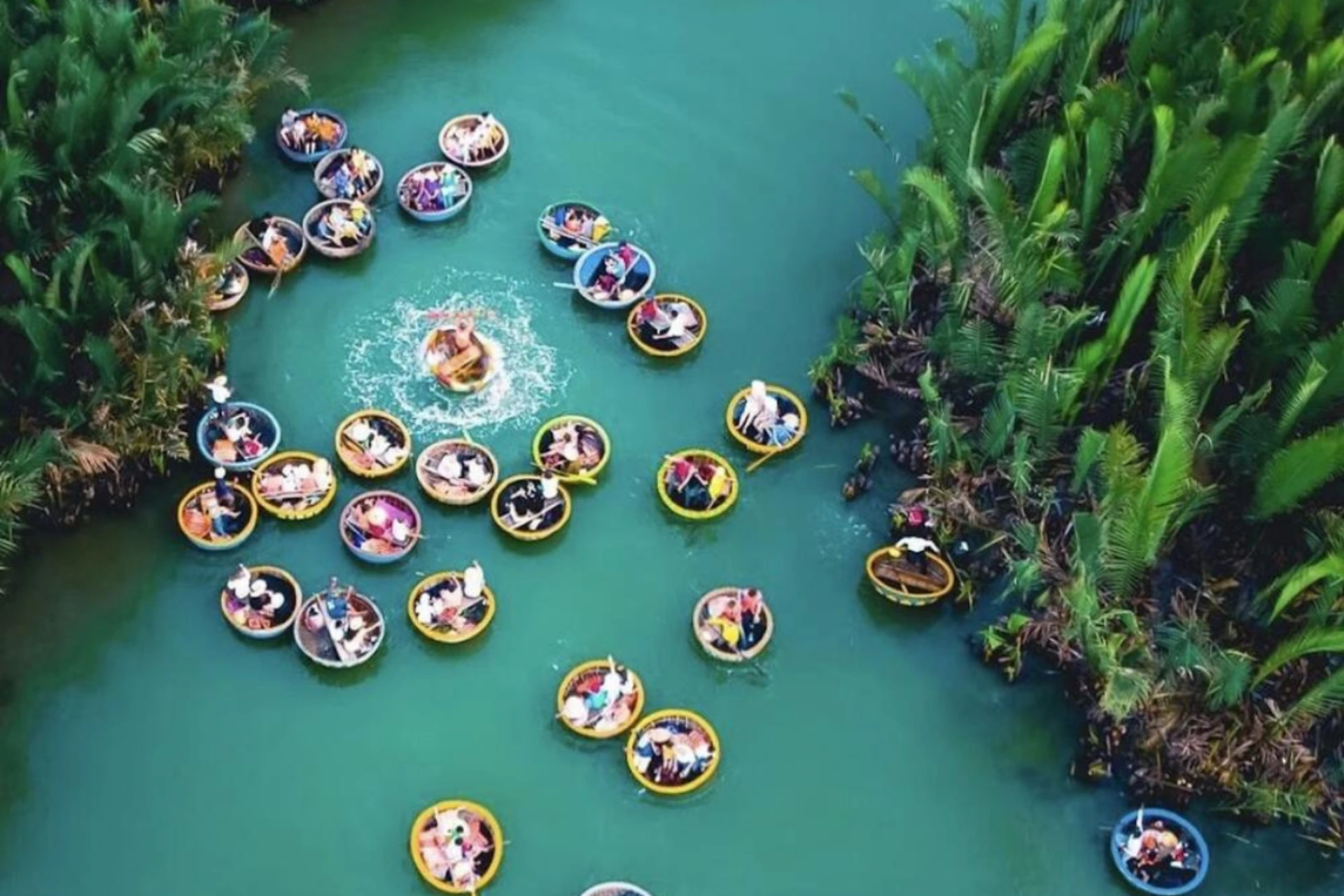 Round boats floating on blue-green water in Coconut Forest Da Nang
