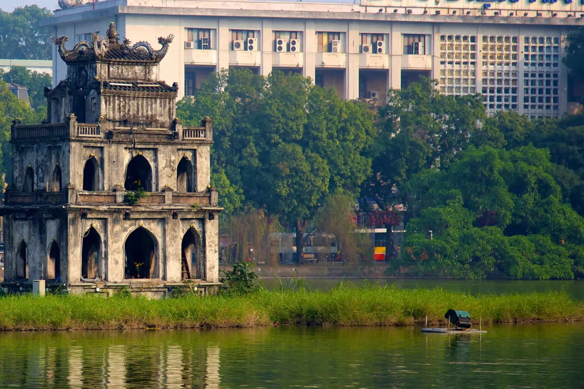 Old stone tower by water at Hoan Kiem Lake Hanoi
