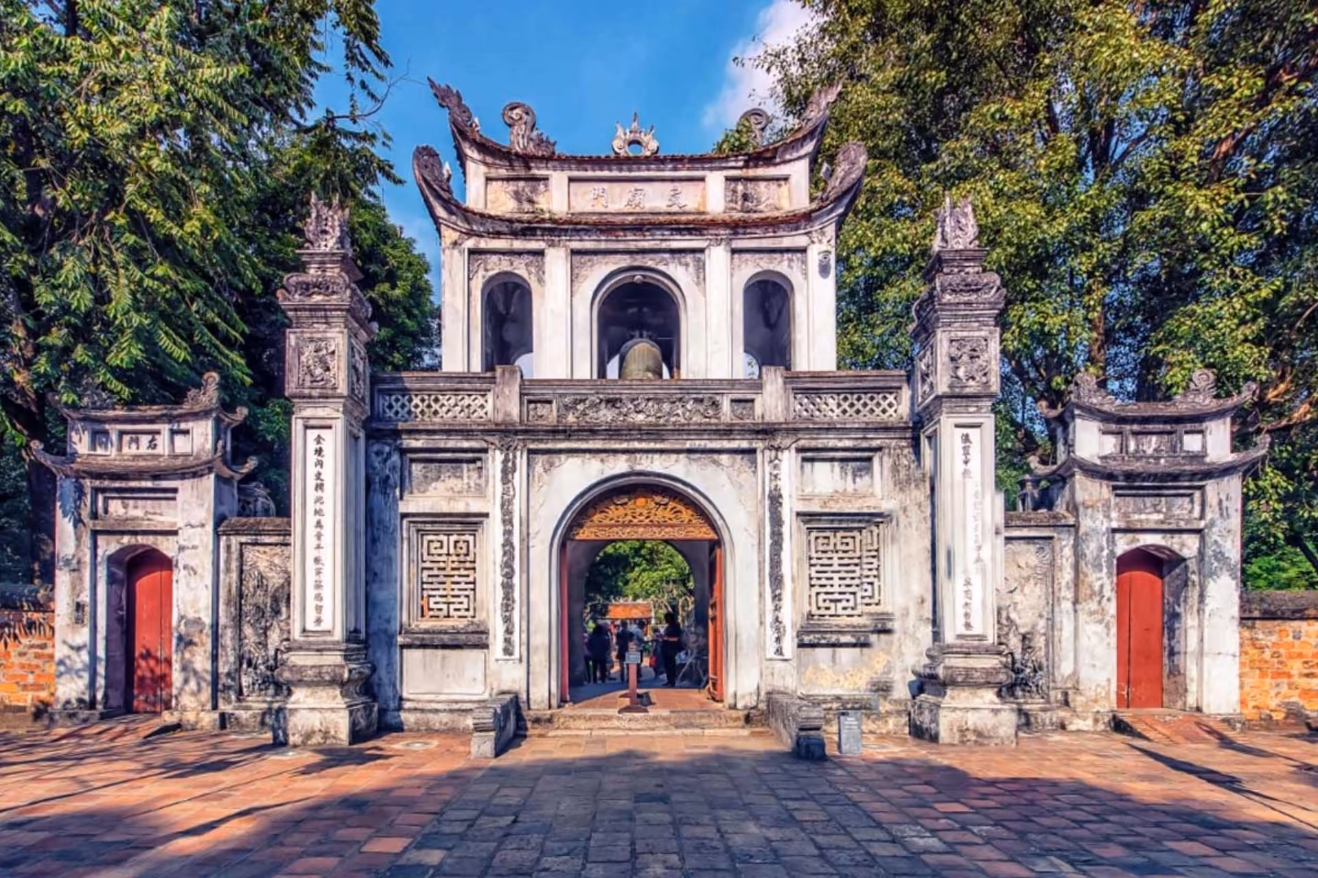 Temple of Literature stone gate with red doors and curved roof